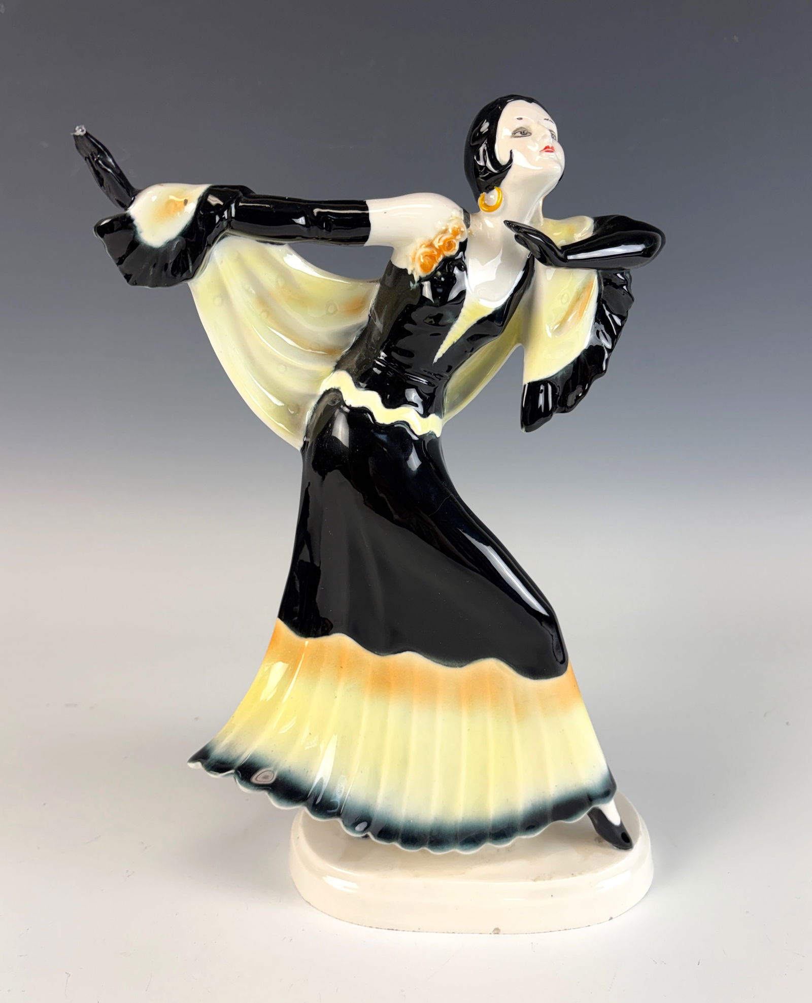Art Deco Lady Dancer Figurine: Art Deco figurine depicting a dancer with black gloves with long black skirt, marked on the bottom, very good condition, 12” tall and 7” wide.