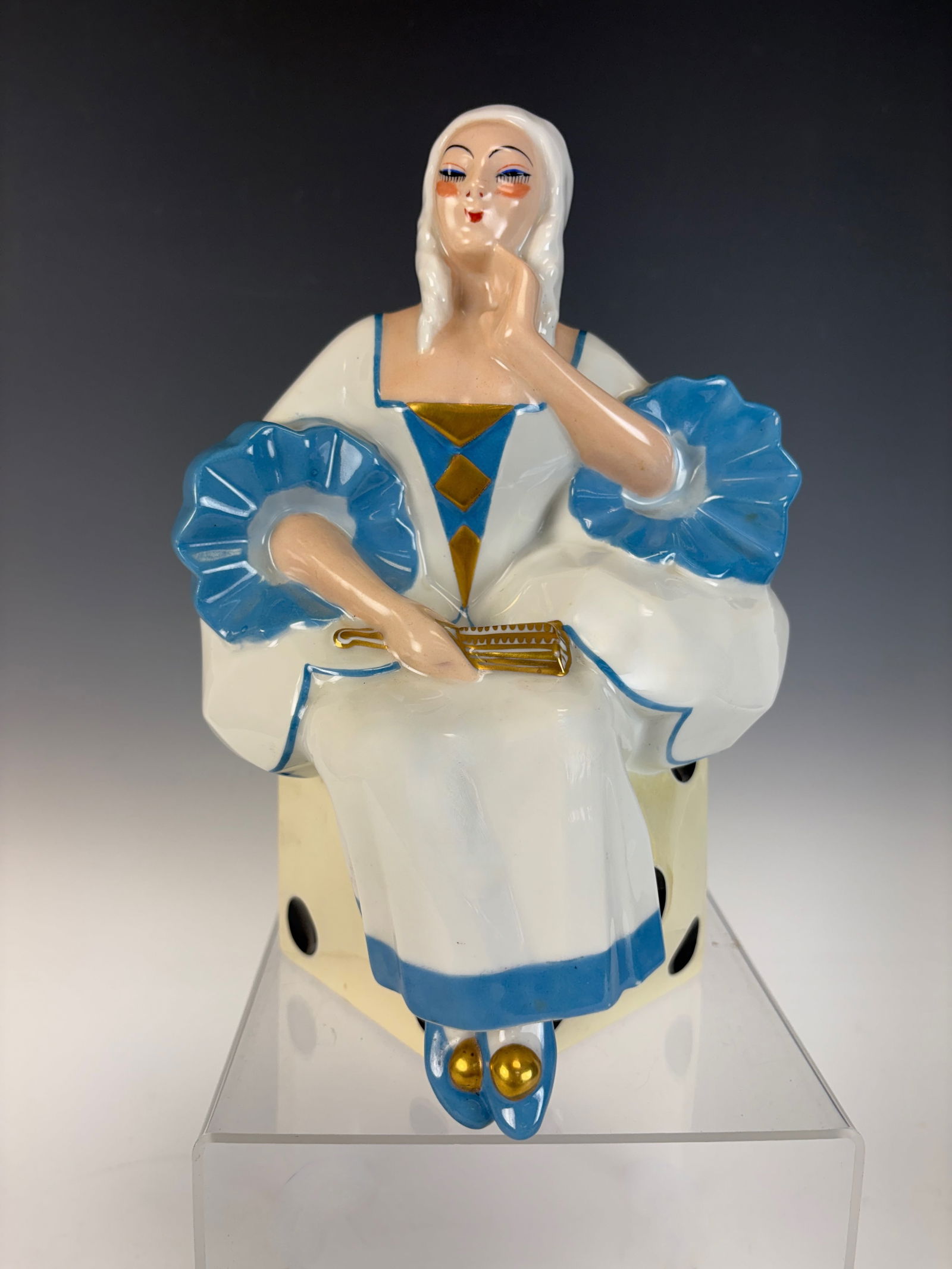 Art Deco Limoges Perfume Lamp Lady with Fan: An Art Deco perfume lamp featuring a stylized woman seated atop a dice, elegantly modeled in porcelain and marked Limoges. Excellent condition, 9.5" x 6.5".