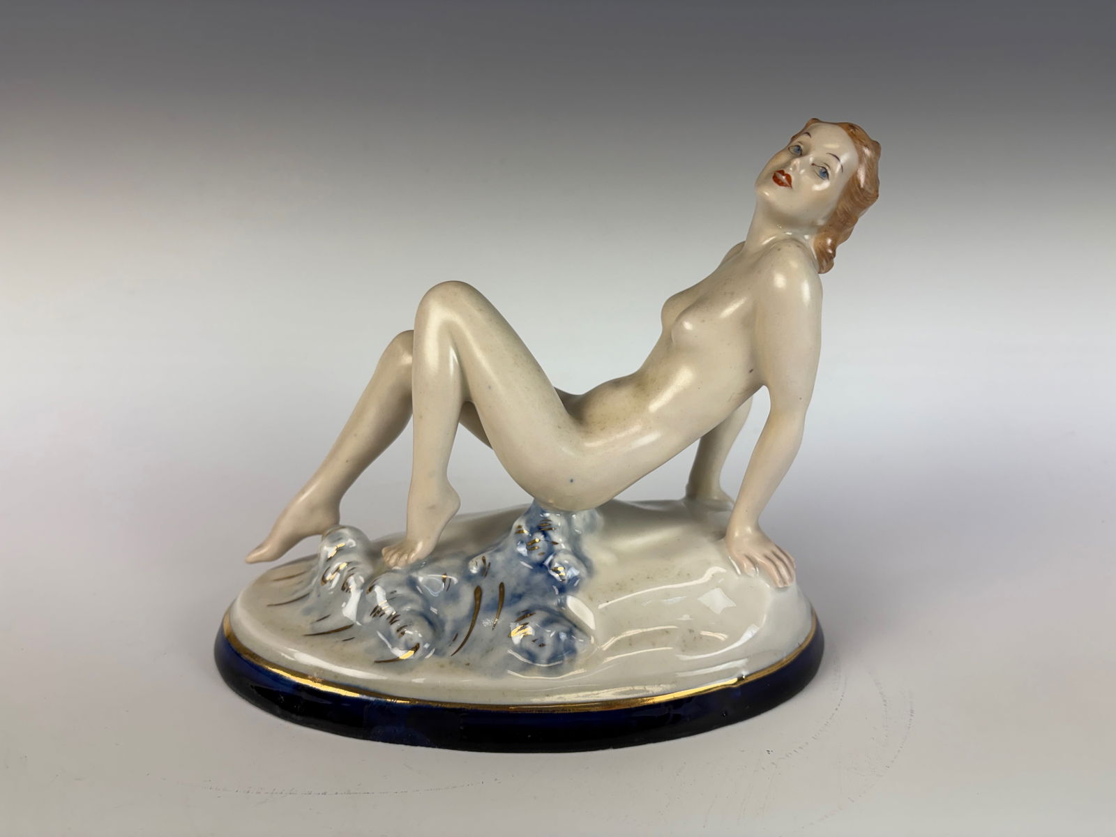 Art Deco Nude Porcelain Figurine: A delicate Art Deco porcelain figure depicting a nude lady sitting on a mound, marked on the bottom “Made in Czechoslovakia” and numbered 207 P3. 6” tall × 7” wide × 3.5” d