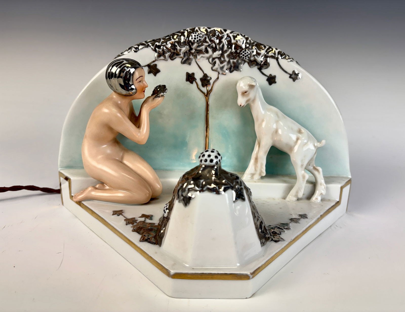 German Night Light Girl with Camera and Goat: A most unusual porcelain night light depicting a young girl with a camera taking a photograph of a goat, charmingly modeled with fine detail and period character, blue underglaze mark for Villenauxe L