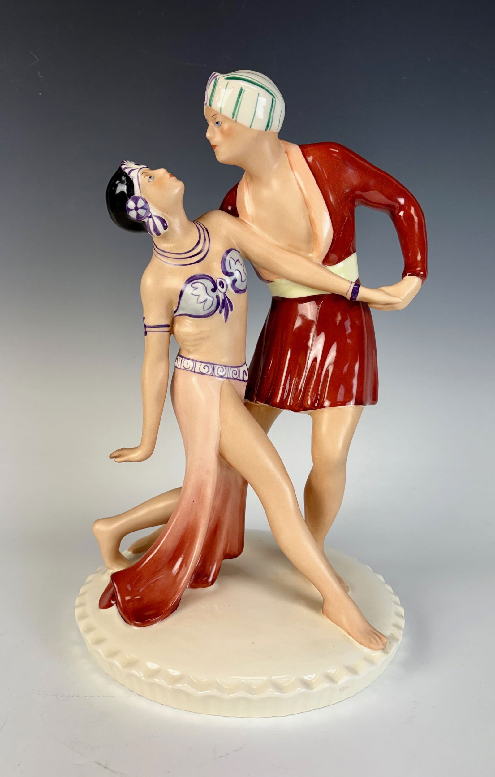 Royal Dux Art Deco Dancers Figurine: A glazed earthenware Art Deco figure depicting an exotic dancing couple, capturing graceful movement and period elegance.13.5” tall × 8” wide × 8” deep. In excellent condition.