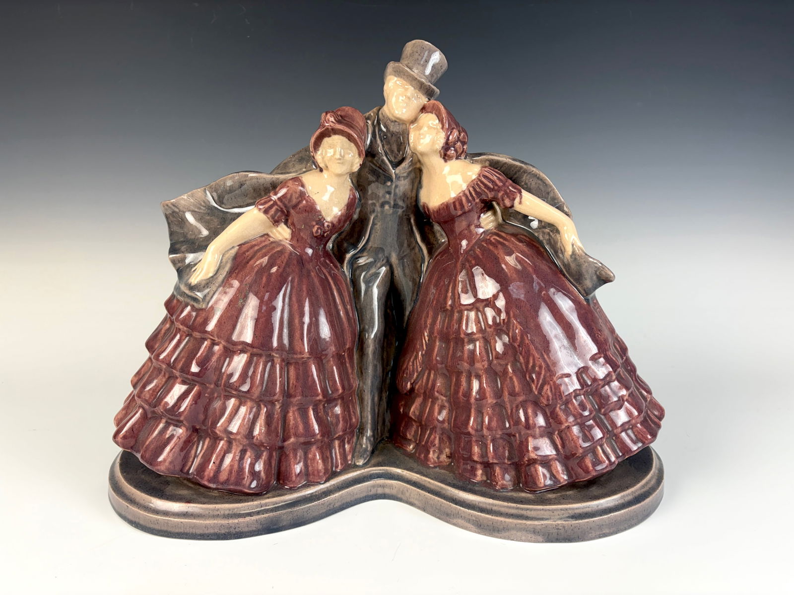 Fanny Rozet Dance of the Old Glazed Figurine: Fanny Rozet (France,1881–1921) Circa 1930, a charming signed glazed terracotta figurine depicting two elegantly dressed ladies with a gentleman in a top hat. impressed on the bottom “Made in Franc