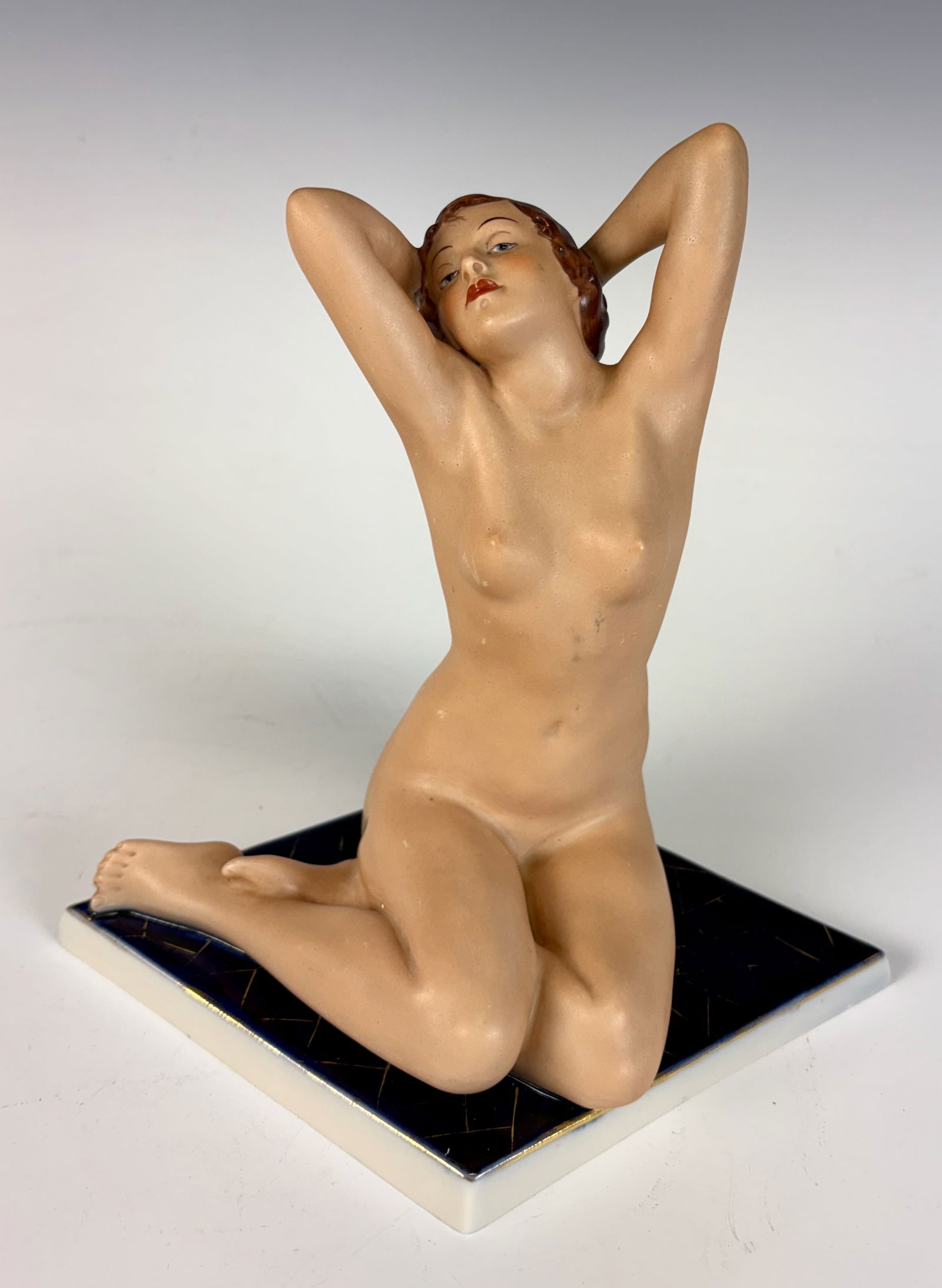 Royal Dux Porcelain Nude Lady Figurine: A Royal Dux porcelain figurine of a nude lady, signed on the bottom with the Royal Dux pink triangle mark. In excellent condition. 7” tall × 8” wide.