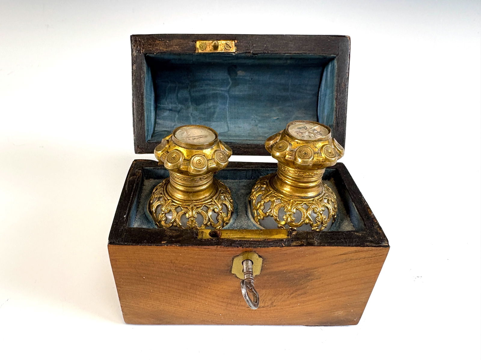 Pair Antique French Perfume Bottles with Box: circa 1880, a pair of crystal perfume bottles housed in original wooden chest with domed lid. The glass bottles have gilt brass tops and are decorated with scenes of Paris, with the interior of the bo