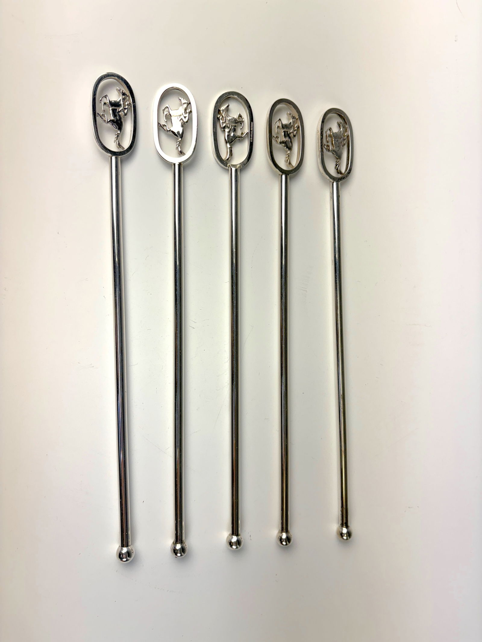 5 Tiffany & Co. Sterling Silver Horse Swizzle Sticks: A set of five rare sterling silver horse form swizzle sticks by Tiffany & Co., each marked Tiffany & Co. Sterling silver, In very good condition. Total weight: 66 grams. 8” long.