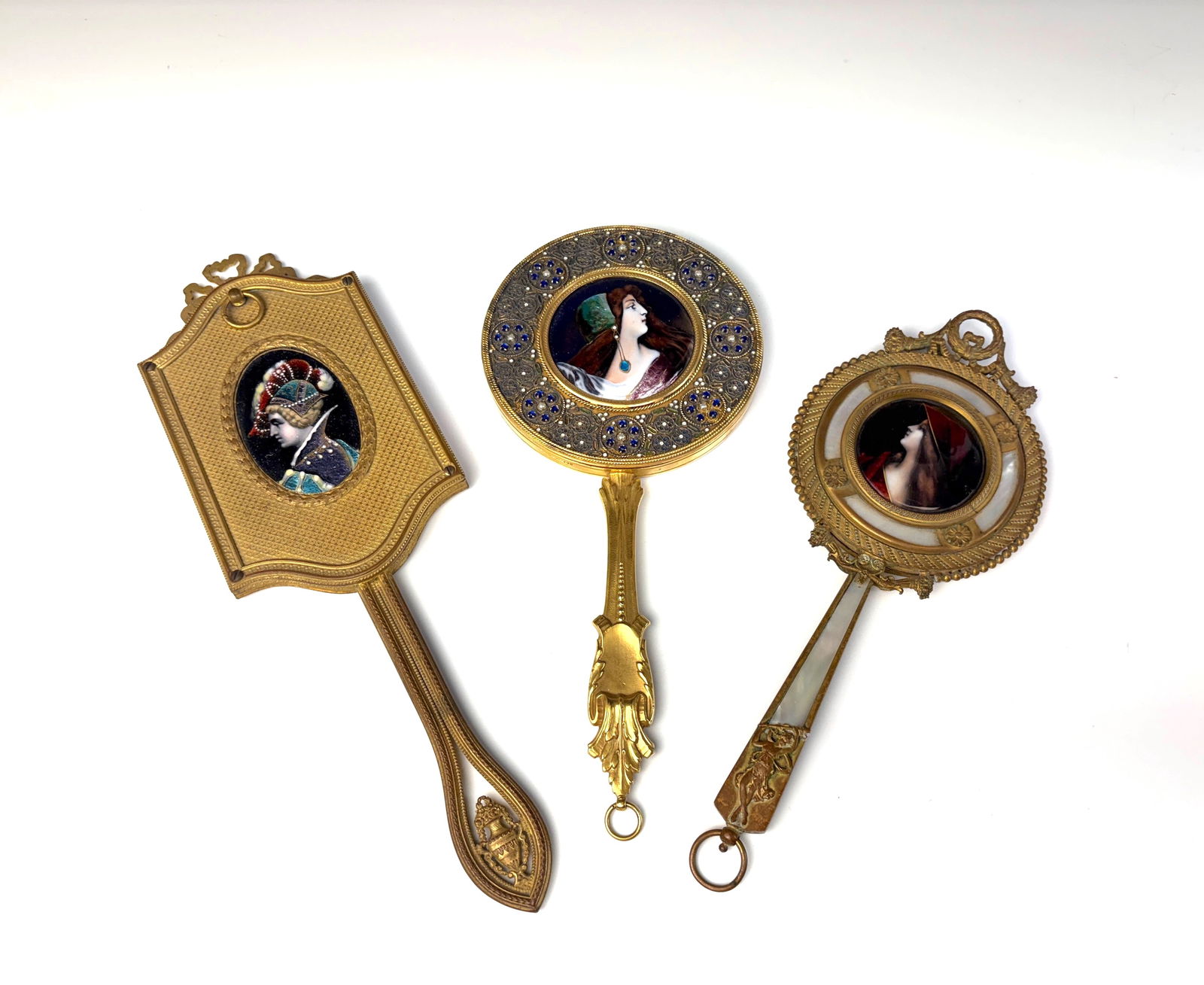 Three Antique Enamel Hand Mirrors: Circa 1900,A lot consisting of three antique enamel hand mirrors. All three have very good enamel, while the mirrors have damage 11.25” longest..