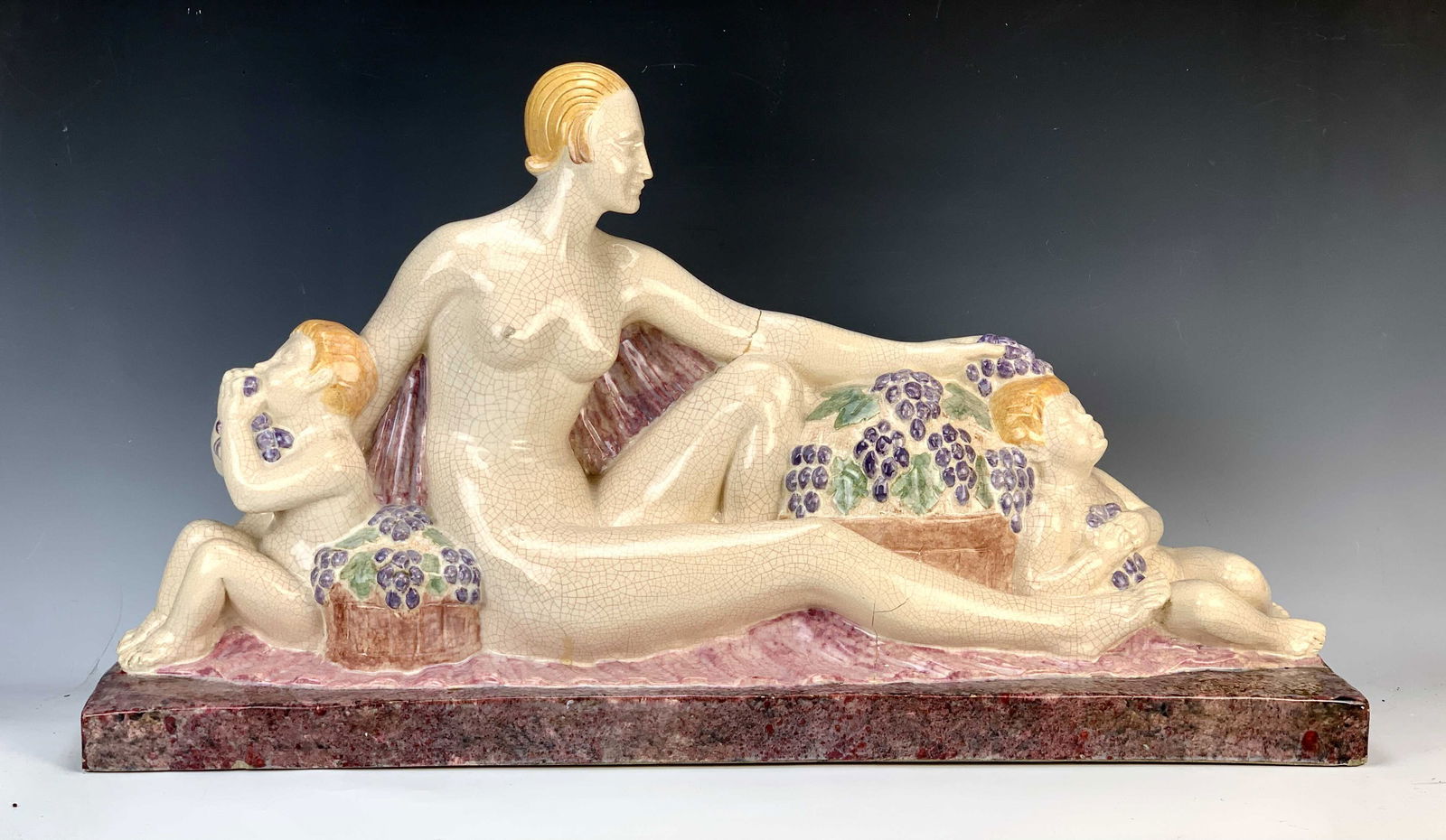 Large Art Deco Ceramic Mother w/Children Figurine: Circa 1920's is this large wonderful art deco figurine depicting a nude mother with her 2 children amongst bowls of grapes. Signature is on right platform and is illegible (H. Faugiere?) Overall good