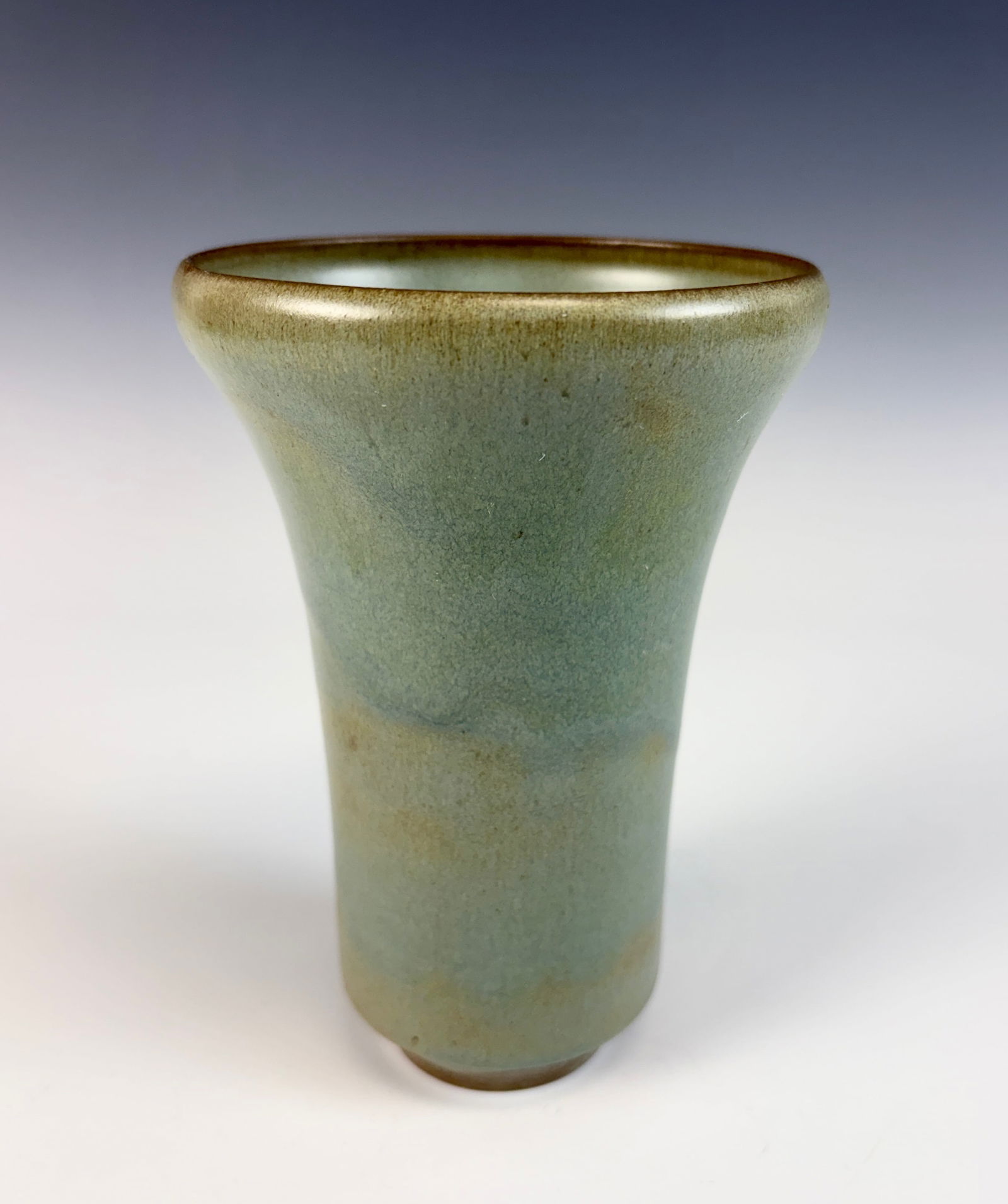 Gertrude & Otto Natzler Cylindrical Vase Sgd: A studio art pottery vase by Gertrude Natzler (Austrian, 1908–1971) and Otto Natzler (Austrian, 1908–2007), featuring a celadon glaze with a subtle variegated surface over a tapering cylindrical b