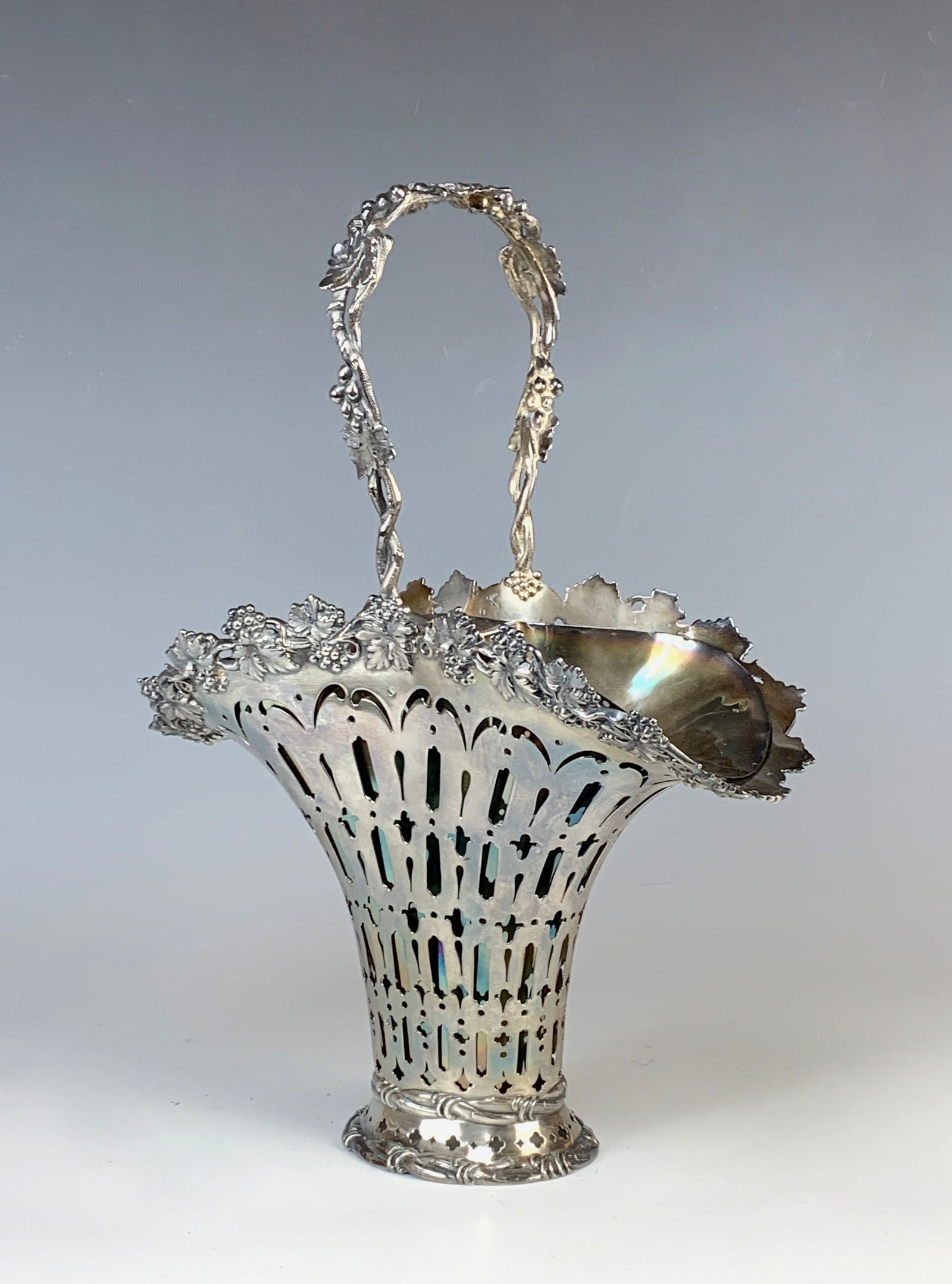 Tiffany & Co. Silver Brides Basket Grapes Design: Beautiful pierced cut Tiffany & Co. sterling silver brides basket decorated with grapes and vines, has its original silver plated liner. The basket is marked "Tiffany & Co. Makers 15631 & 7139 Sterlin