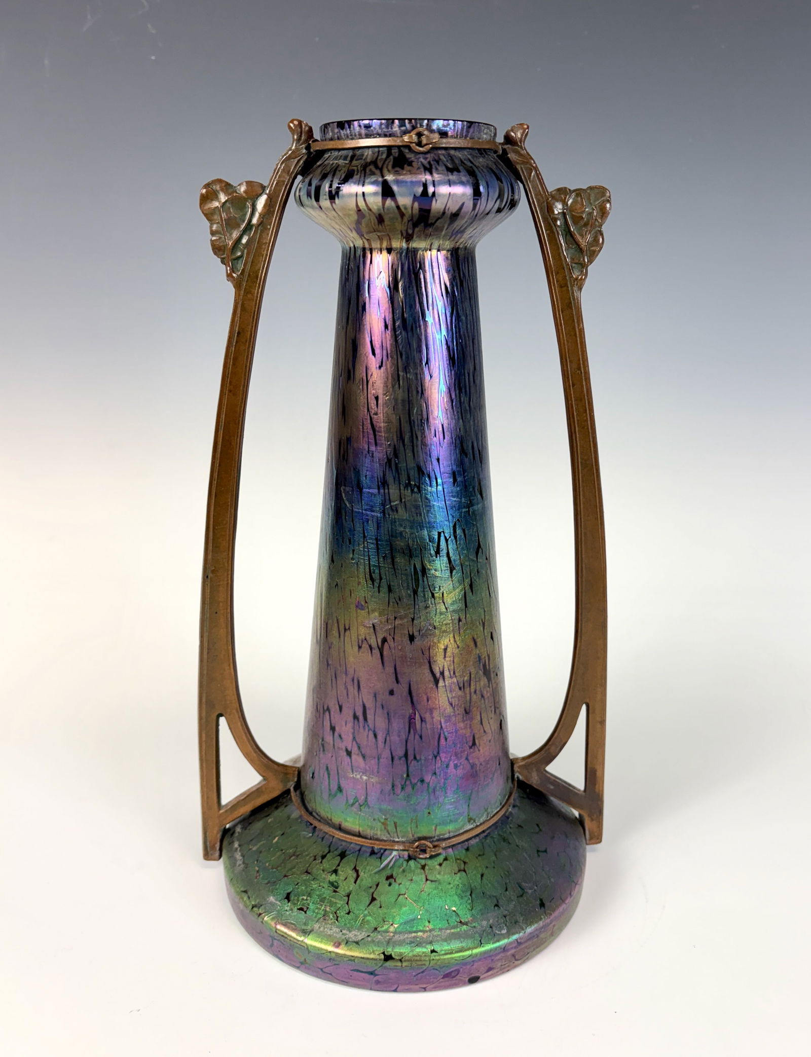 Johann Loetz Art Nouveau Bronze Mounted Vase: An elegant Art Nouveau vase by Johann Loetz (1848–1933), featuring luminous iridescent glass in rich blue with green and gold highlights, mounted within an ornate double bronze handle frame, very go
