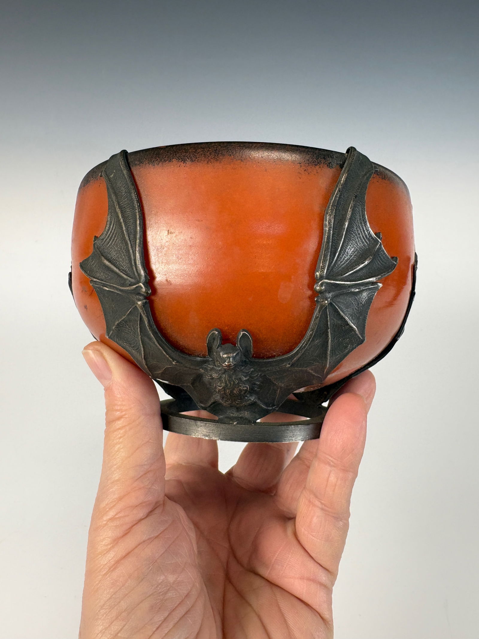 Rare Verrerie d’Art Lorrain (VAL) Bat Bowl: circa 1900 A rare bat bowl by Verrerie d’Art Lorrain (VAL), mottled orange art glass fitted with iron mounts depicting three bats extending from the top rim to the base. Signed on the frame “Val"