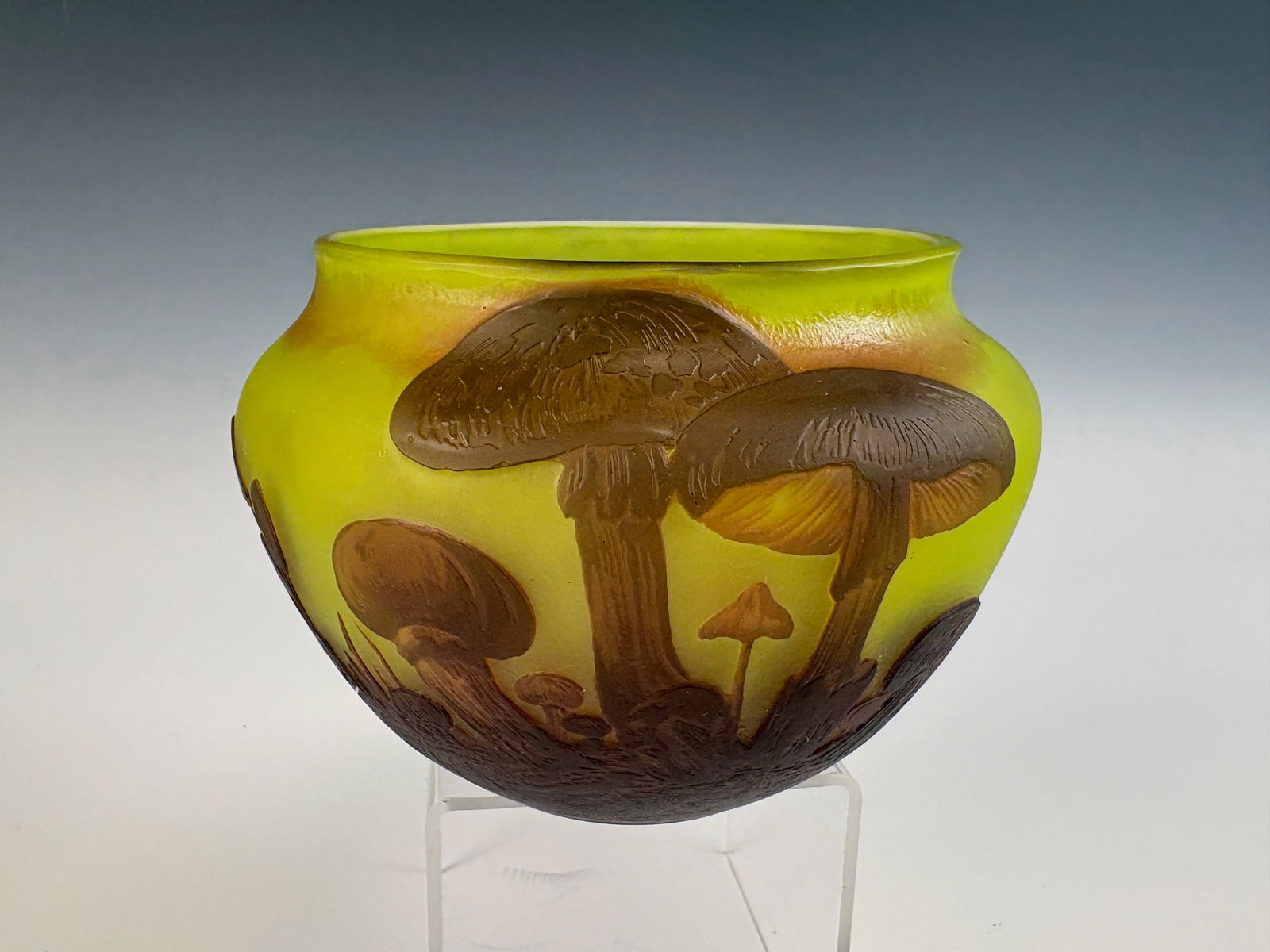Daum Nancy Signed Art Glass Mushroom Vase: A signed Daum Nancy glass vase with a yellow ground decorated with dark orange mushrooms encircling the body, a charming example of French Art Nouveau glass design. 3.78” tall × 6.5” wide