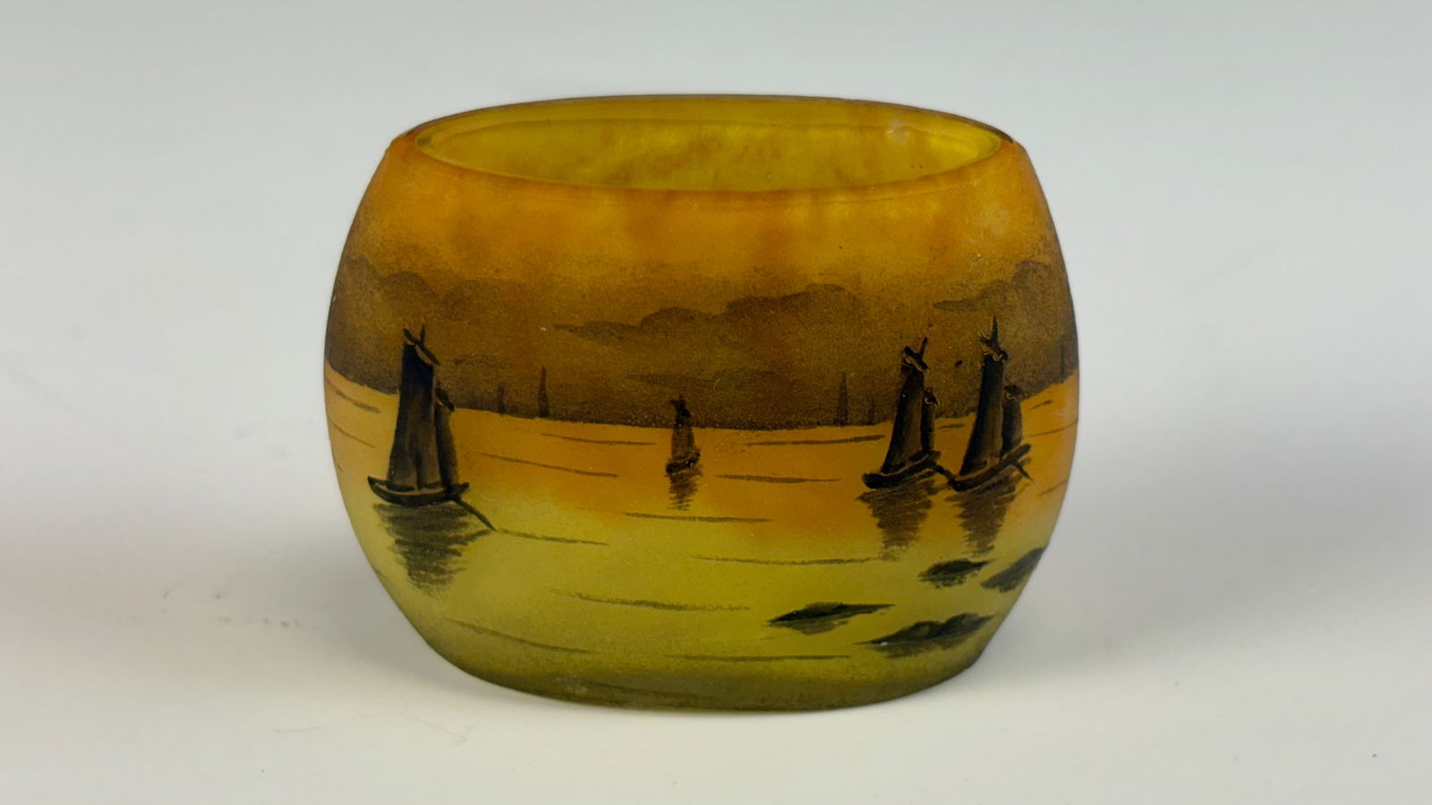 Daum Nancy Venetian Boats Miniature Cameo Vase: Daum Nancy,signed, a miniature cameo glass vase with an orange and yellow ground, decorated with sailboats in the Venetian style, signed Daum Nancy. In very good condition. 1.5” tall × 2.25&rdq