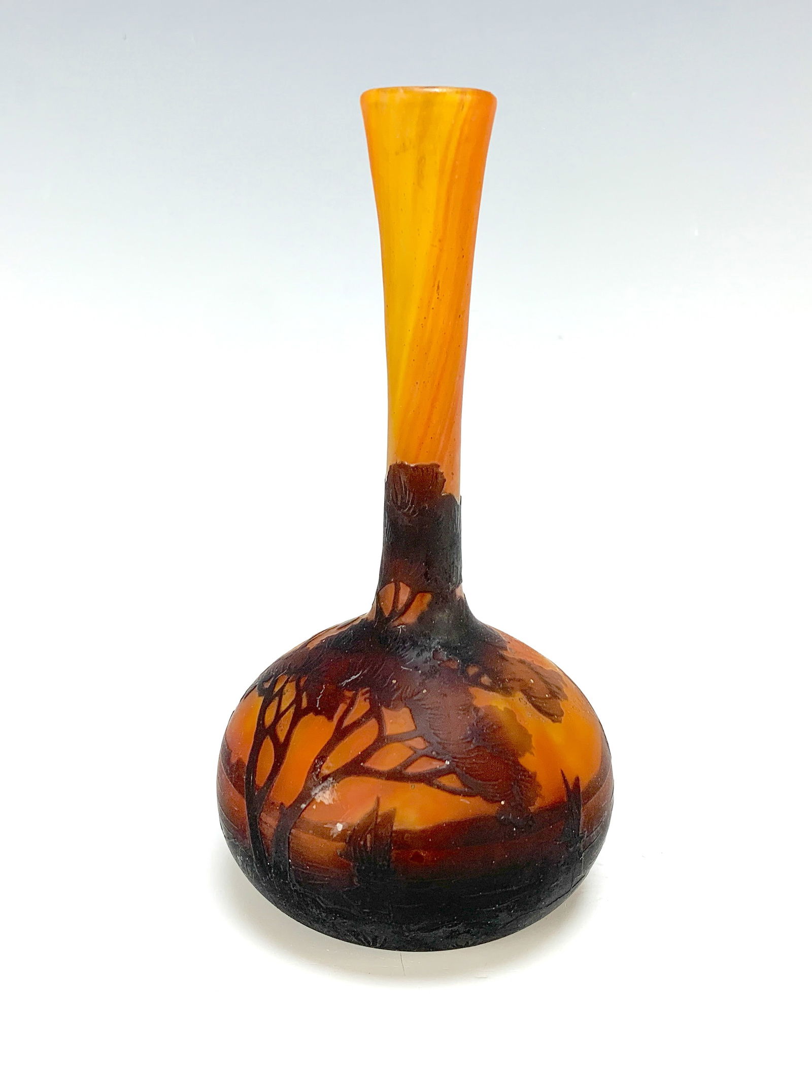 Daum Nancy Scenic Cameo Glass Vase: Daum Nancy scenic cameo glass vase. Having a bulbous body in a long neck multi-layered cameo glass acid etched in brown on an orange ground, decorated with boats on a lake with mountains and trees. Si