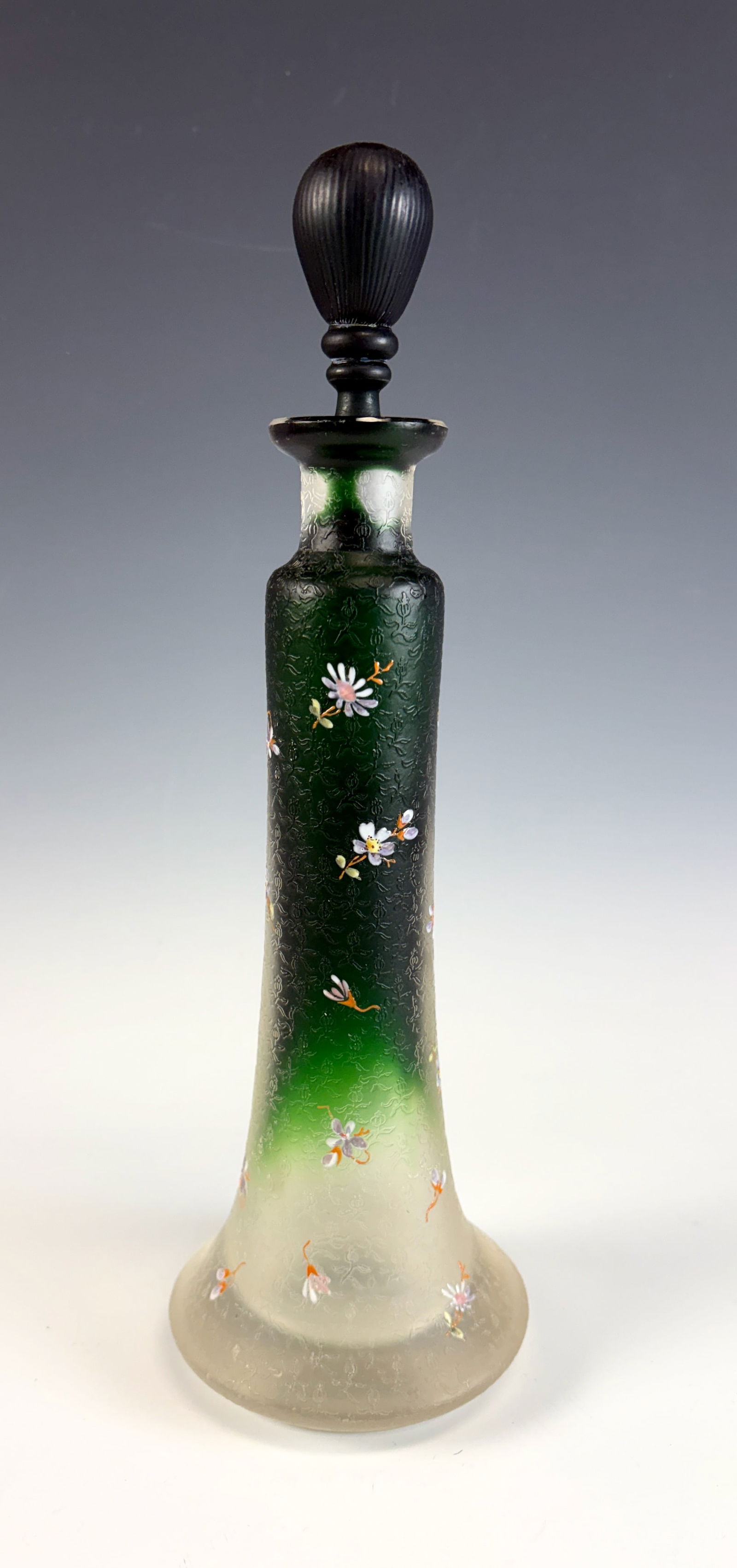 Moser Style Tall Decanter / Perfume Bottle: A tall Moser-style decanter or perfume bottle dating to the 1920s, featuring green glass with a clear frosted base decorated with floral motifs, in very good condition.11” tall.