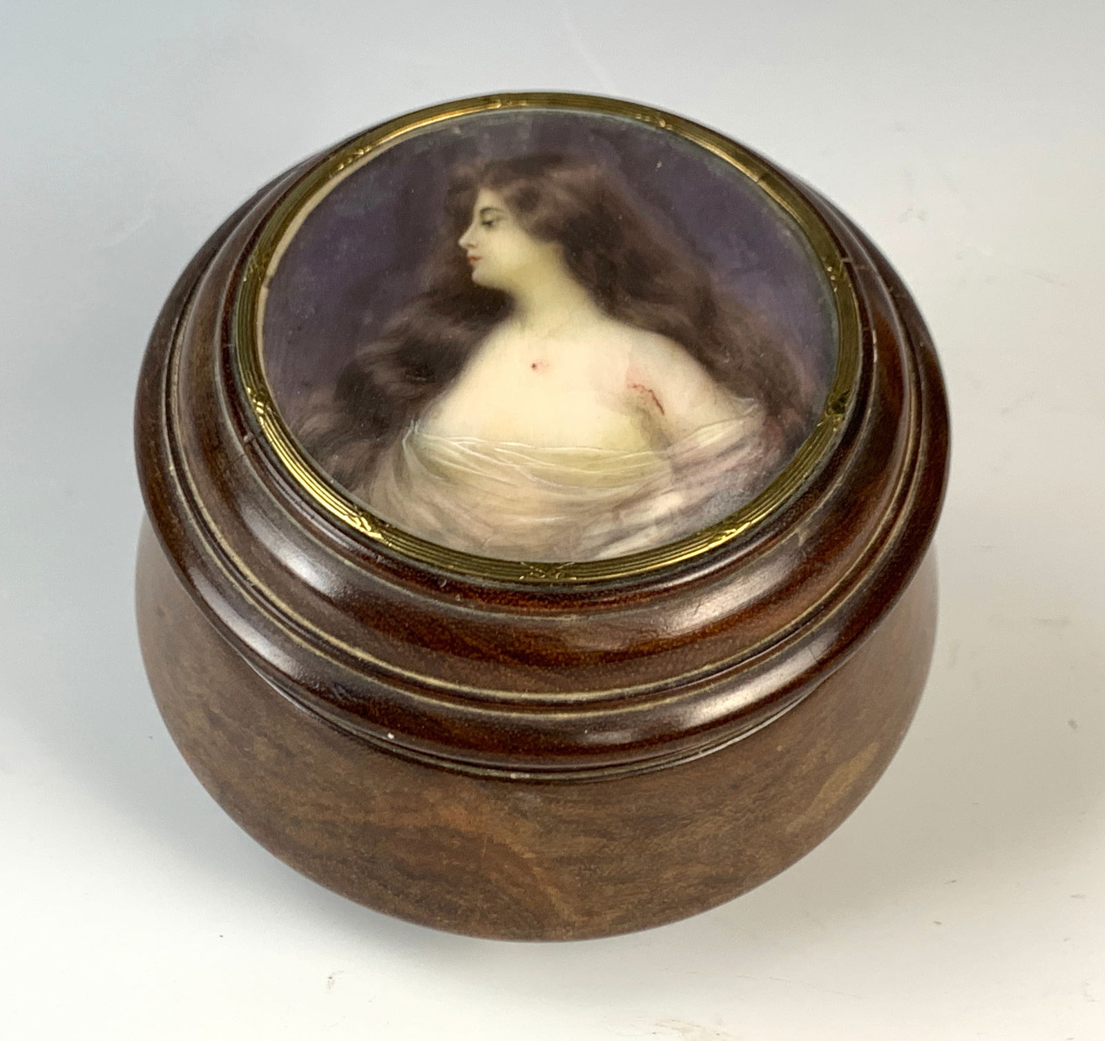 Round Walnut Wood Box w Handpainted Portrait: Circa 1900, ladies vanity box in walnut wood with spherical bone feet, top mounted with circular painting of a pretty woman with glass front, top and bottom with age cracks. 3.25" tall x 5" diameter