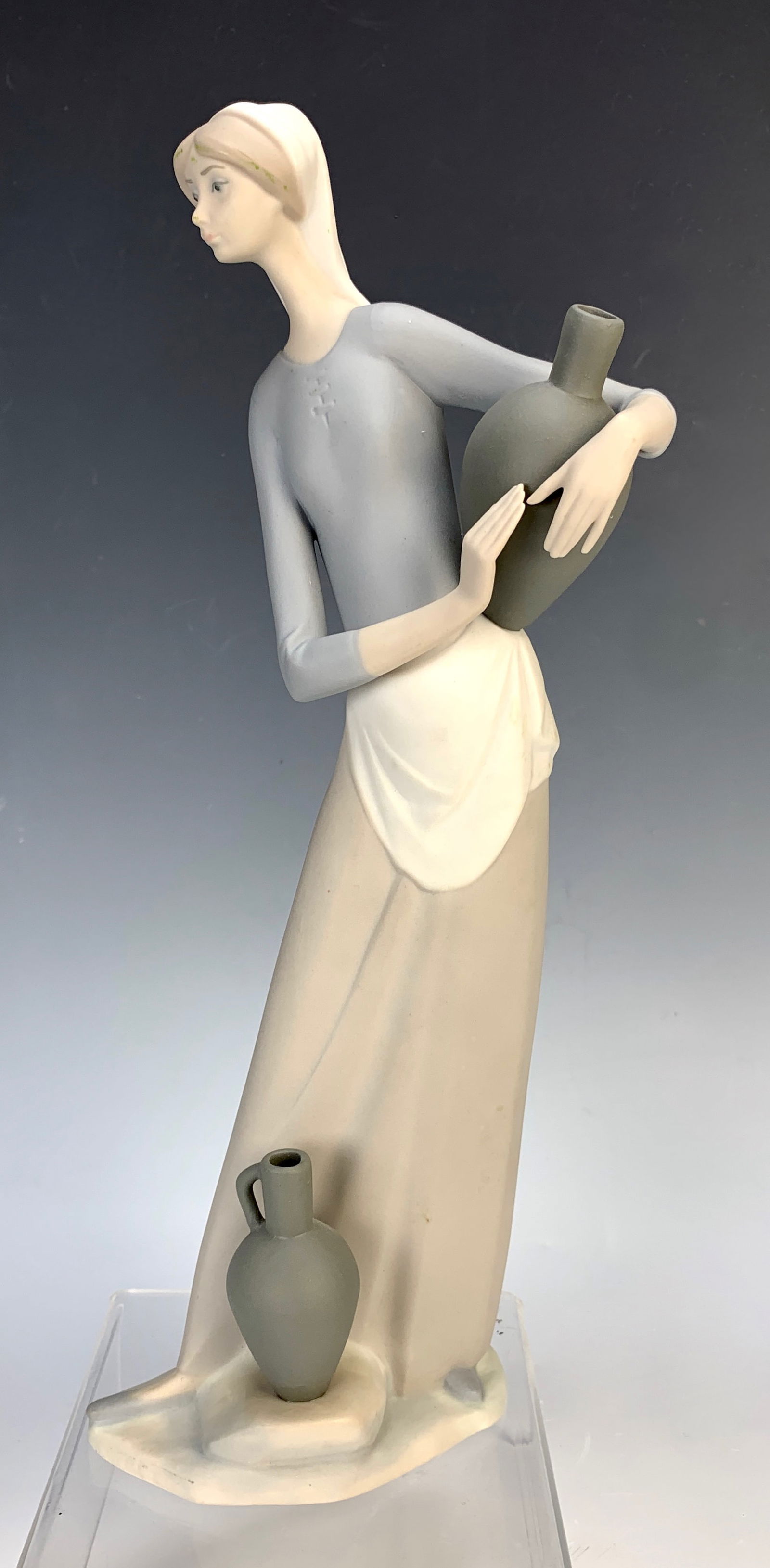 Lladro "The Jug Carrier": Retired in 1985 #4875, matte finish, signed on bottom, slight scuff mark on the back of head, very good condition, 13" height.