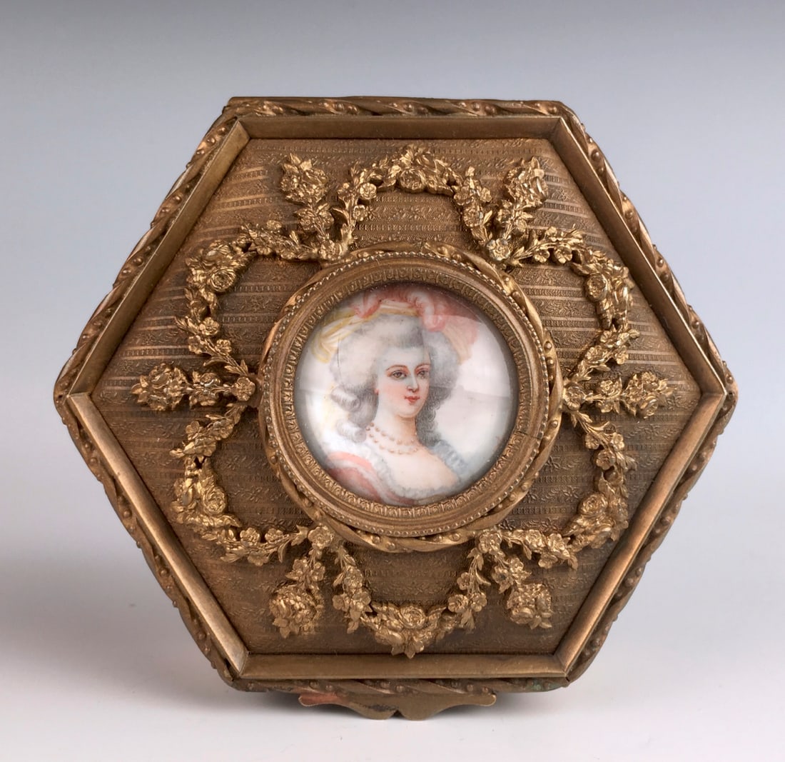 Antique Gilt Bronze w/ Painting Ring Box C. 1900: Hexagon shaped gilt bronze box having a painting of a lady with fancy hat, lined interior, very good condition, 1.75" x 4".Eligible for in-house shipping (U.S. only). Please inquire.