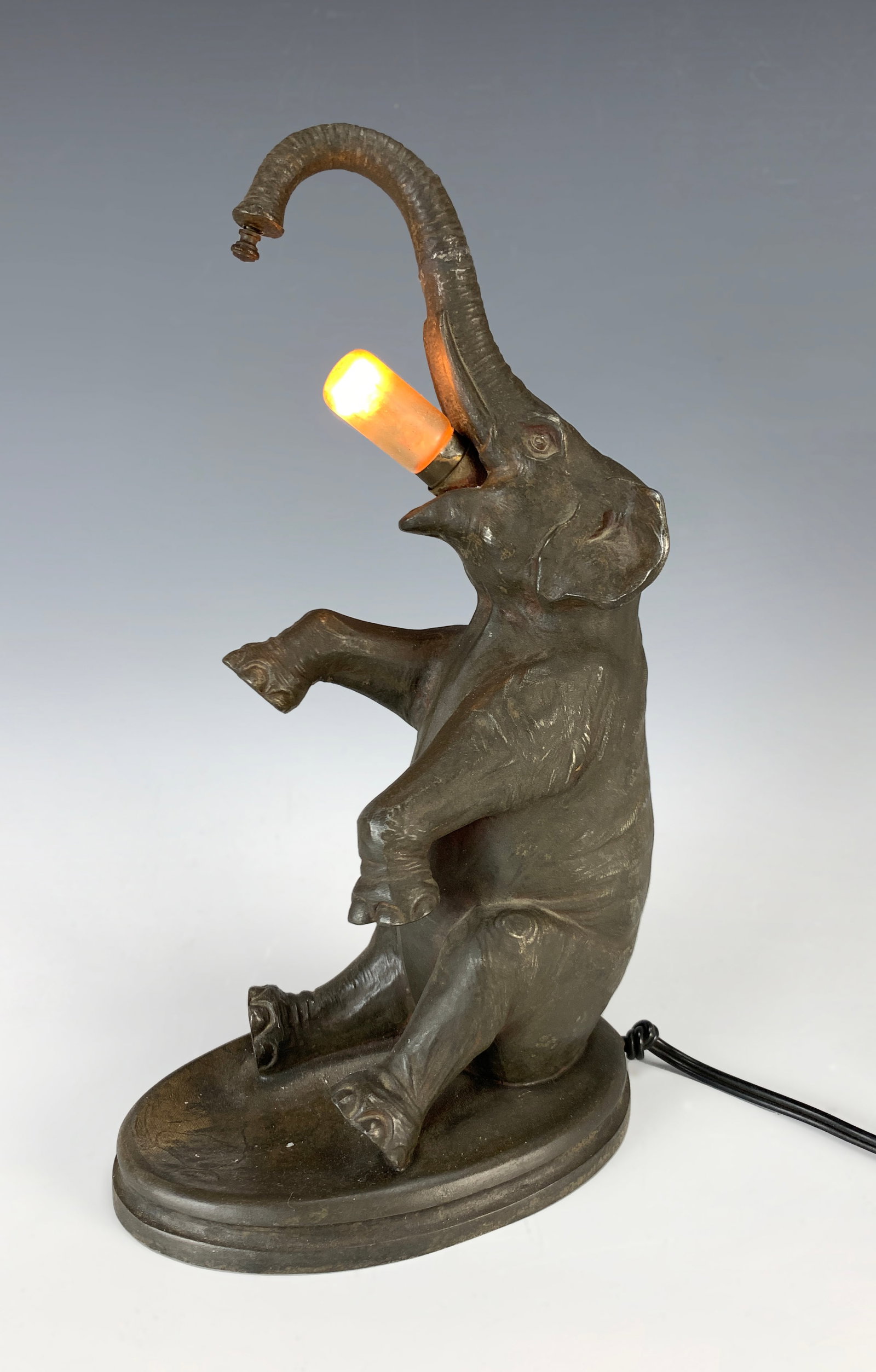 Sitting Elephant Figural Lamp Early 1900's: Great novelty lamp from the early 1900s. Has an on/off cord switch which works. Made of metal. 10.5" tall, good condition.Eligible for in-house shipping (U.S. only). Please inquire.