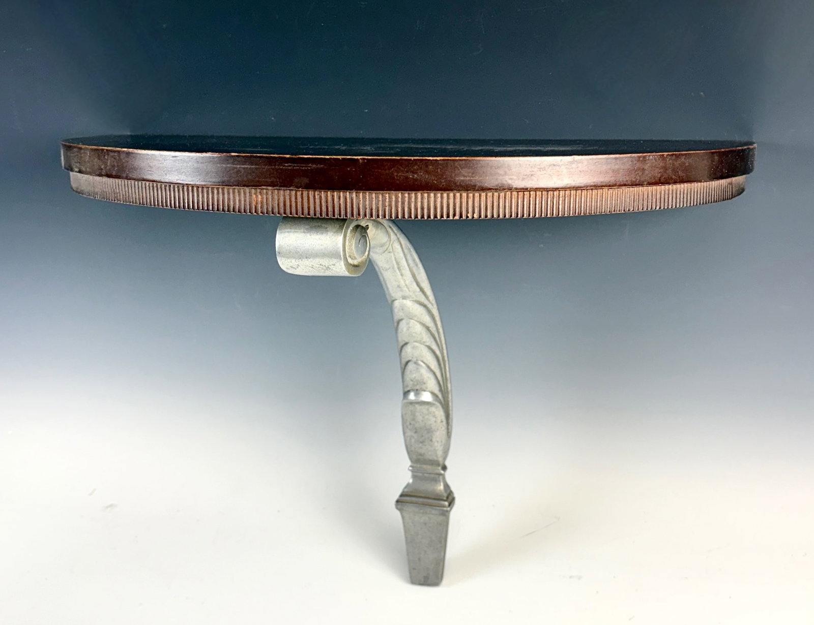 Art Deco Wooden & Metal Wall Shelf: Circa 1920, semi circular wooden shelf supported by a decorative art deco design metal support, good condition, 18" x 10"