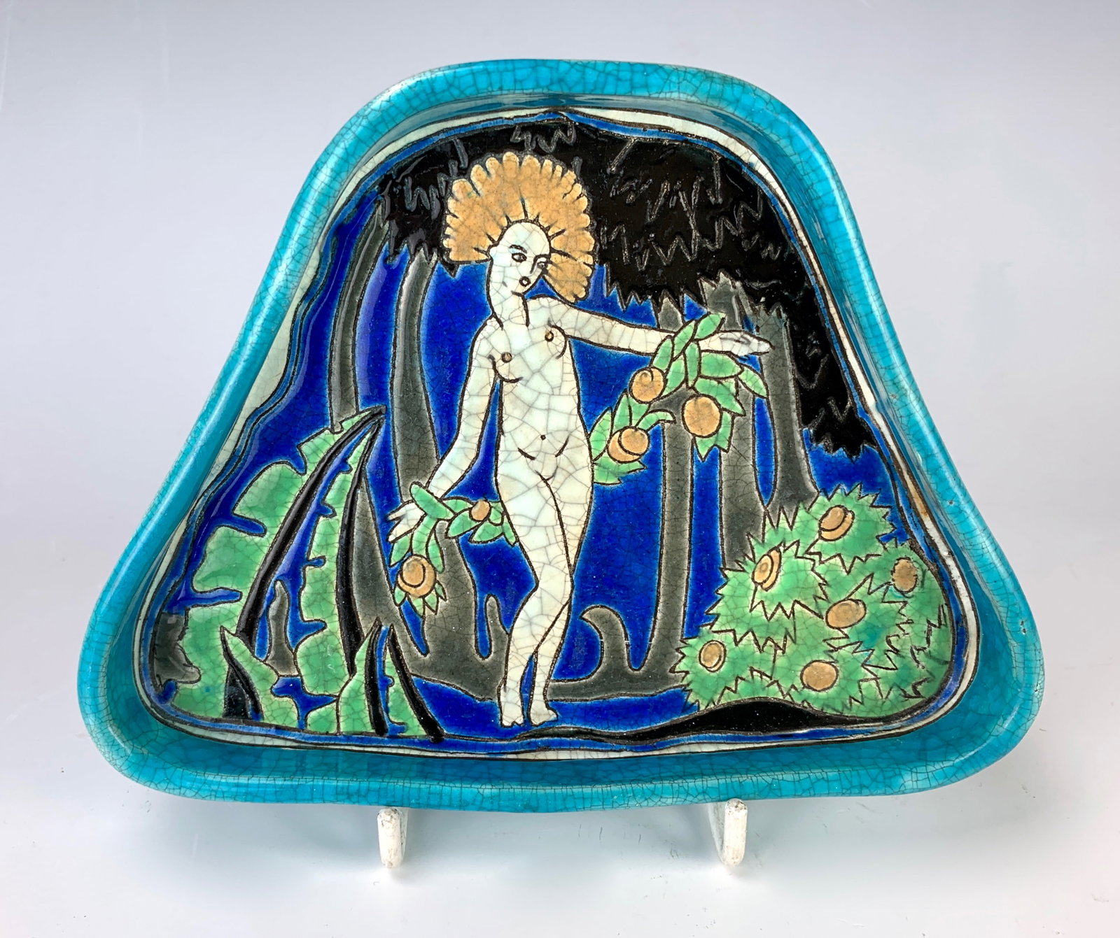 Longwy Rare Art Deco French "Nude" Pottery Dish: Circa 1920, nude woman among fruit trees, marked "Longwy France, Pomone Bon Marche" and "2107, 824", very good condition, 6.5" width.Eligible for in-house shipping (U.S. only). Please inquire.