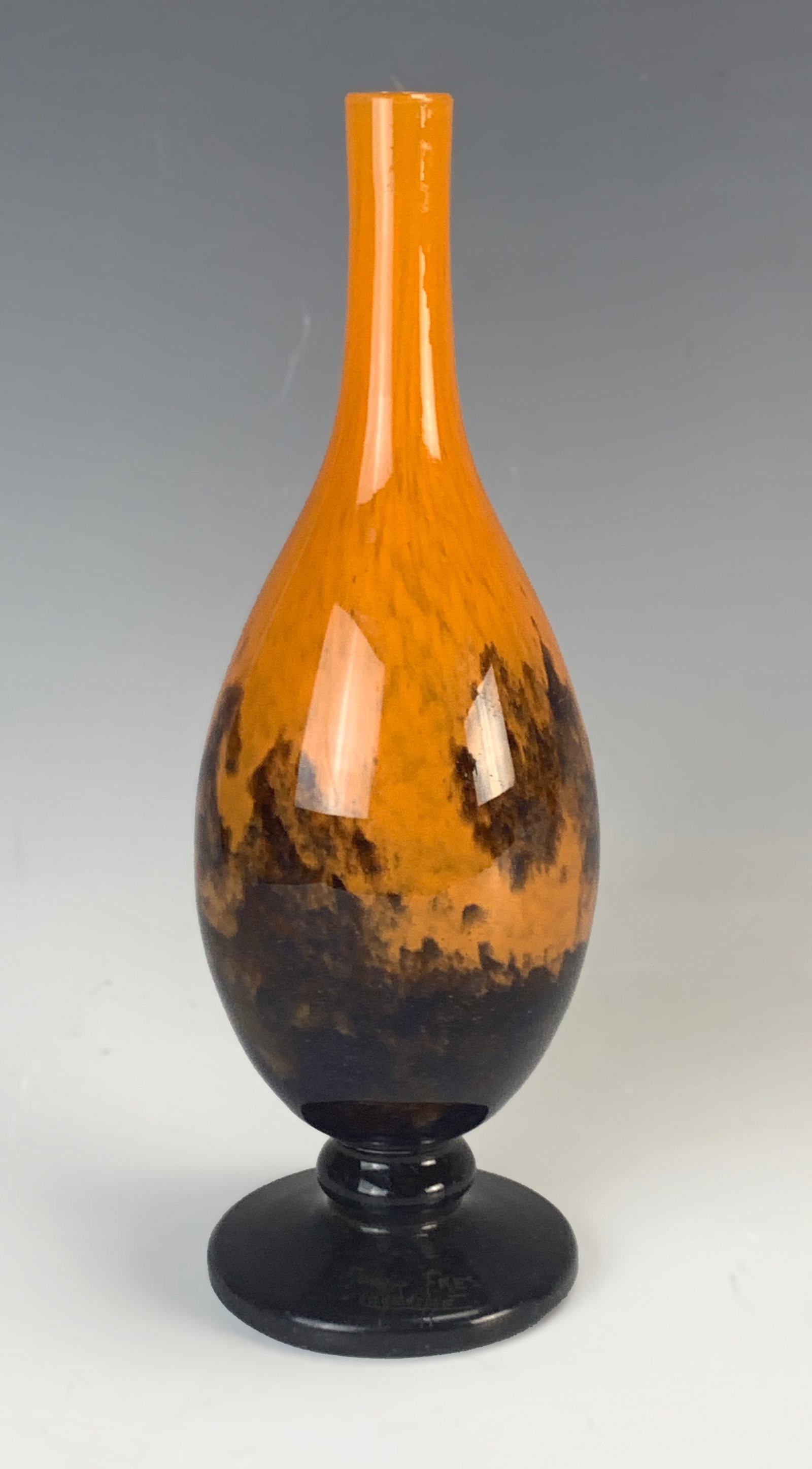 Signed Muller Freres Art Glass Vase: Circa 1920s, featuring a baluster-shaped vase in orange and blue mottled glass, signed on the bottom "Muller Freres Luneville". 8.25" tall. Very good condition.Eligible for in-house shipping (U.S. onl