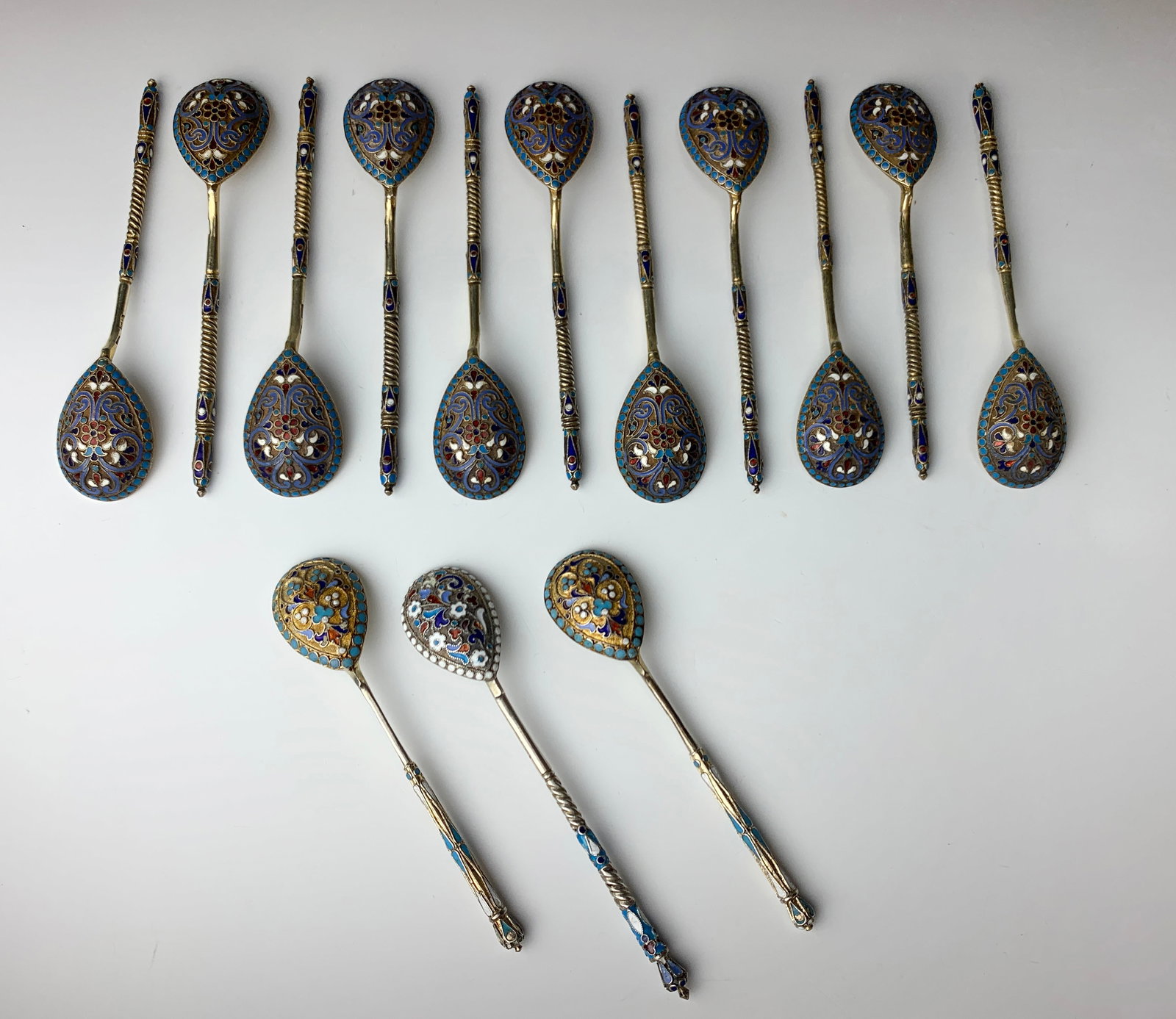 14 Antique Imperial Russian Silver Enamel Spoons: A fine set of 14 antique Imperial Russian silver and enamel teaspoons. 11 marked with 84 Zolotnik and goldsmith CK, and 3 marked with 84 Zolotnik and NM mark.4.5" longest, very good
