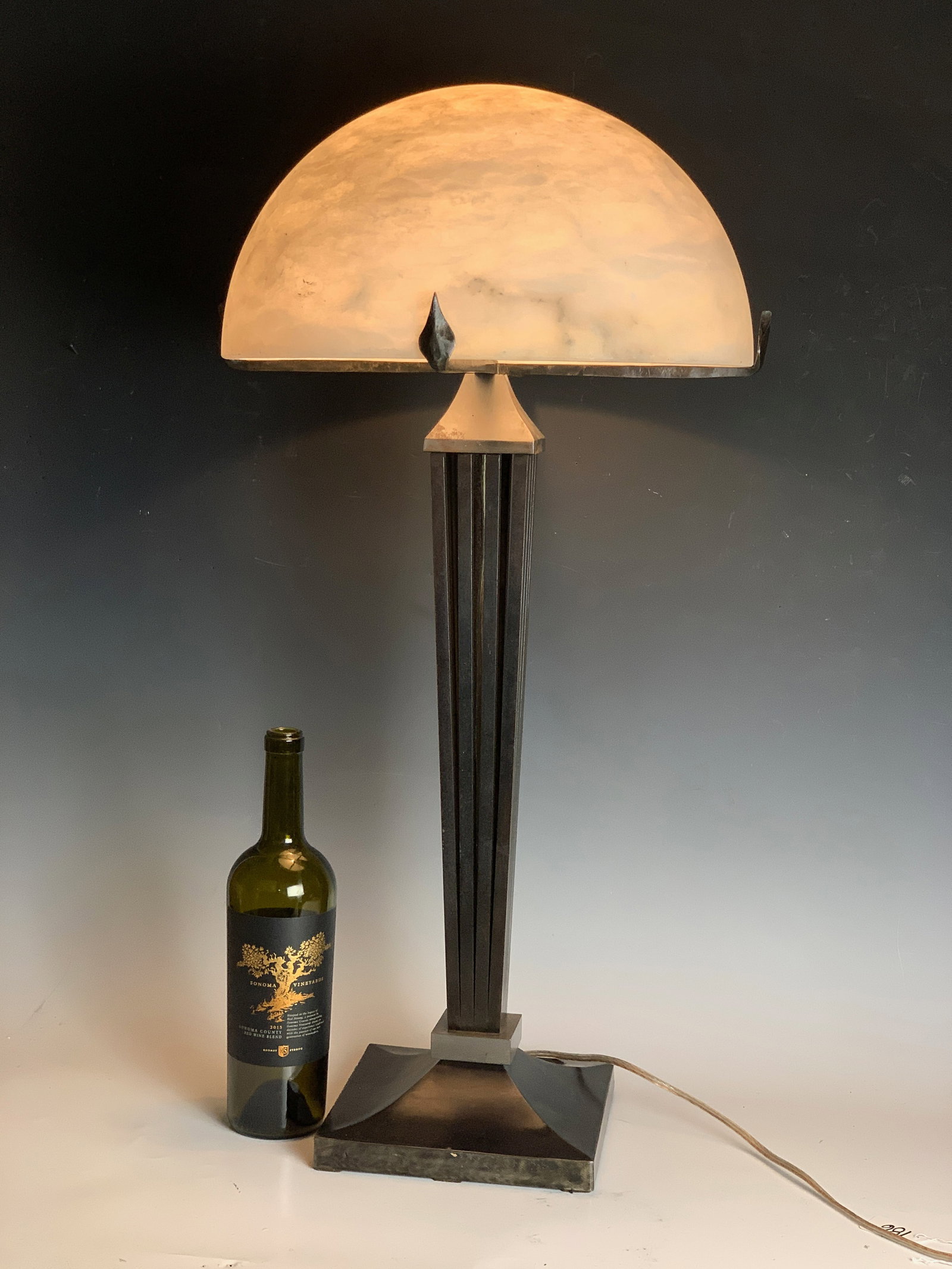 Art Deco Alabaster & Iron Table Lamp: Circa 1920, a stunning Art Deco table lamp having an alabaster semi circular shade mounted on a wrought iron base. 30" (76cm) tall, 15" diameter, very good condition.