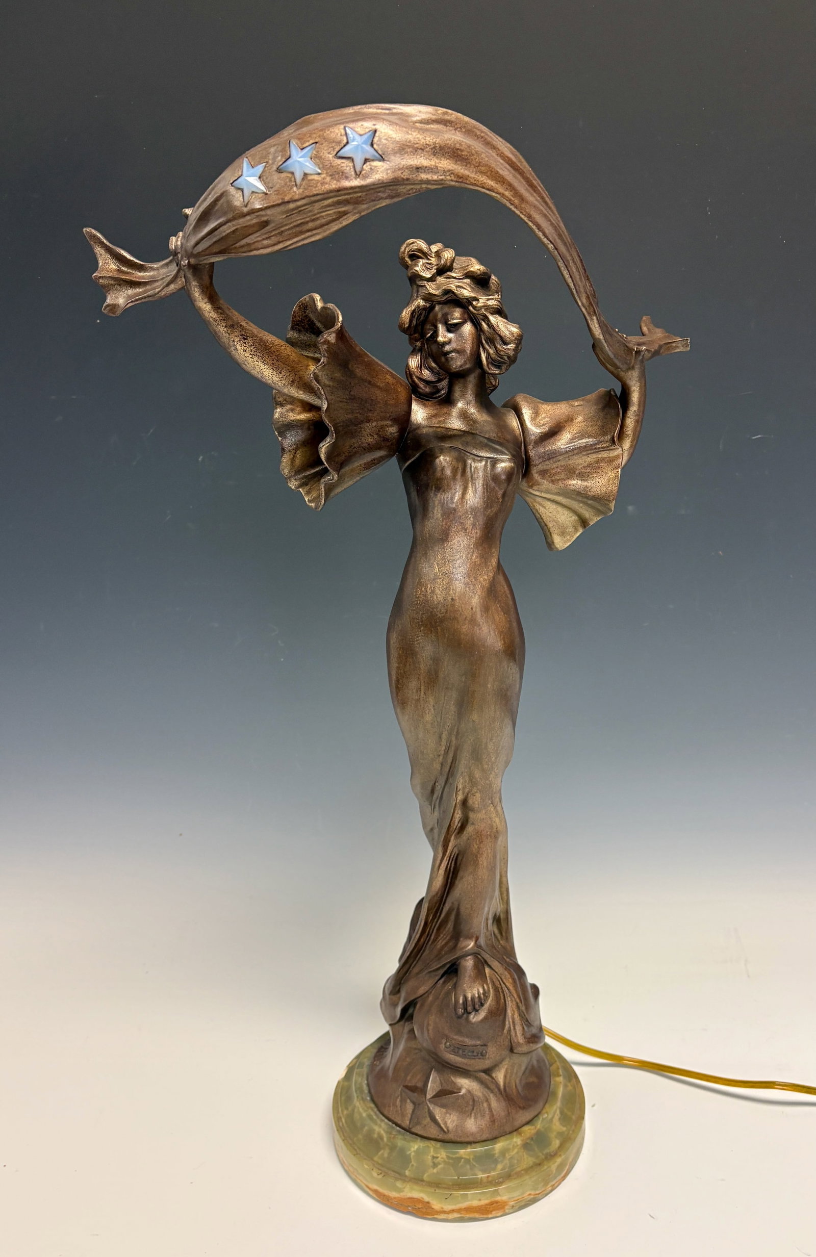 Anton Nelson Art Nouveau Figural Lamp w Stars: Anton Nelson (1880-1910) Outstanding rare art nouveau metal lamp featuring a female figure with a scarf having three opalescent glass stars, with title tag "Stella", has minor professional