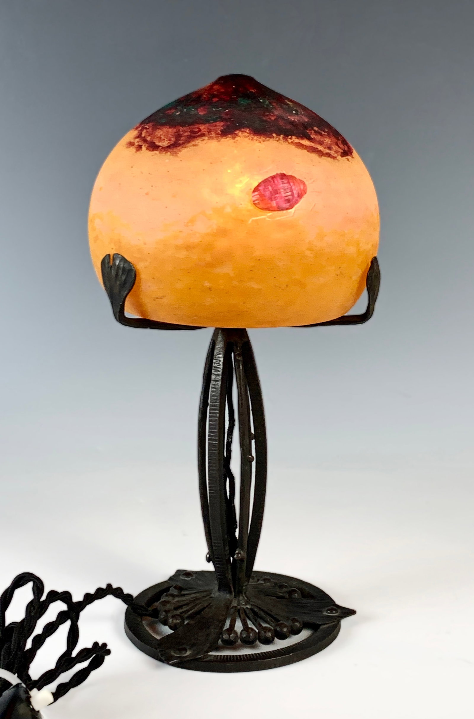 Rare Daum Nancy Lamp with Scarab Insect & Jewel: Circa 1905, a rare and fabulous Daum Nancy lamp with mottled art glass shade with applied scarab beetle and cabochon jewel and mounted upon a wrought iron 3 arm base, rewired with on/off switch, very