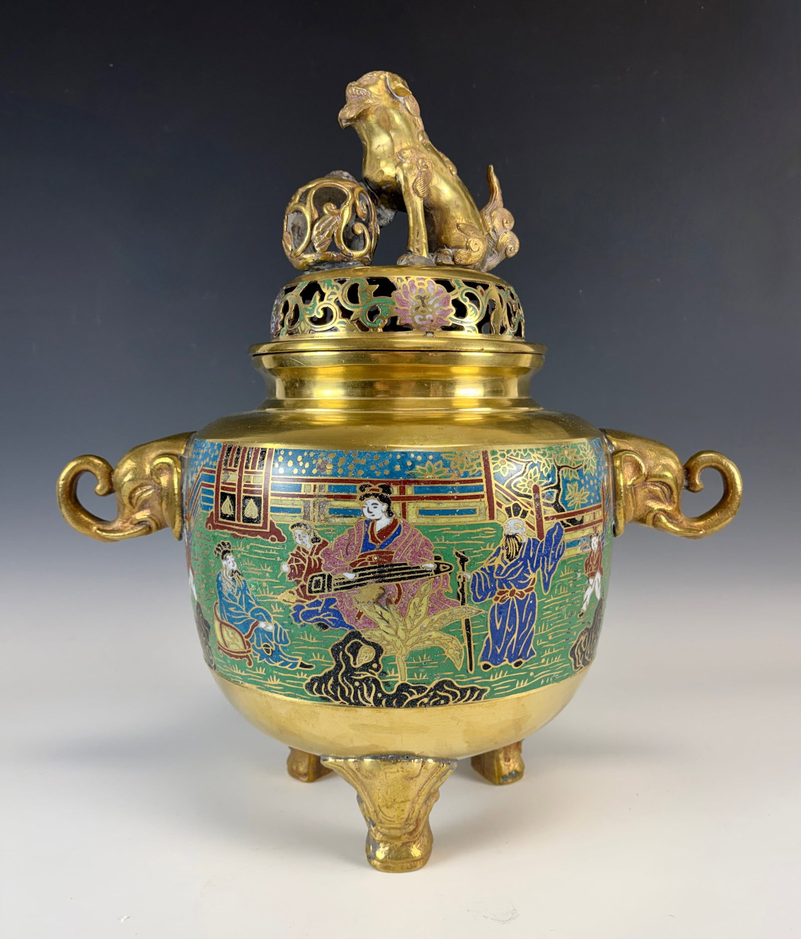 Large Champleve Enamel Incense Burner: Impressive brass and champleve enamel incense burner with figural elephant handles, decorated with palace scenes, foo dog figural finial, finial with old solder repair, minor losses to enamel,