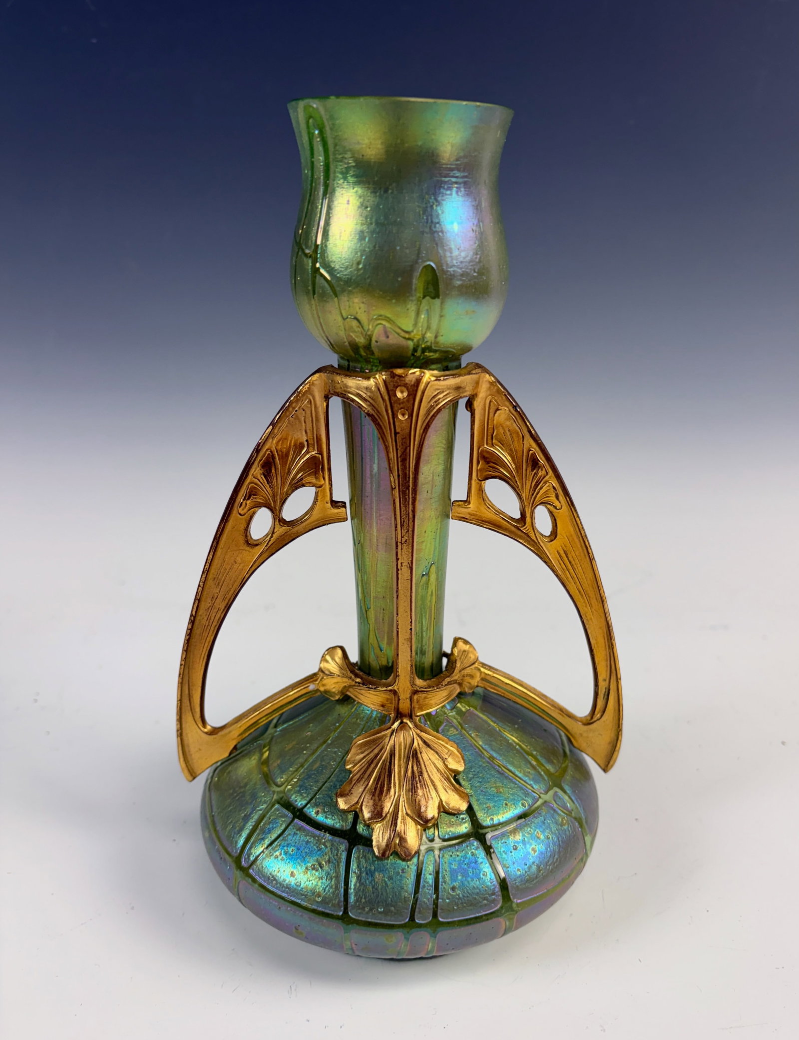 Palme Konig & Gilt Bronze Art Nouveau Vase: Circa 1890, exquisite Loetz type Austrian vase of green and iridescent art glass body encased in a beautiful art nouveau gilt bronze frame with umbel motifs, unusual design with front side only decora