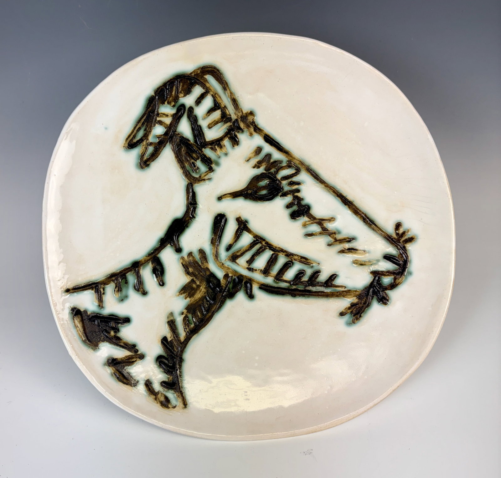 Picasso Madoura Goat Head Ceramic Plate: Circa 1950, a Picasso pottery plate titled "Tete De Chevre de Profil" translates to Goat's Head in Profile, featuring black, brown and green glaze decoration, made at the Madoura Pottery Studio in Val