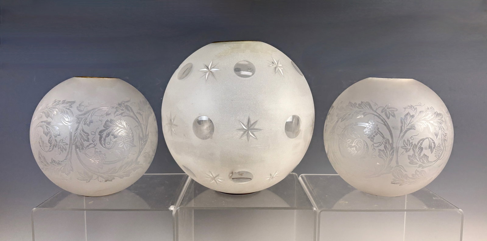 Lot of 3 Glass Globe Shades for Lamps: Group of 3 vintage spherical glass shades, a matched pair acid cut Bullseye design globe shades and a single frosted glass globe shade with Bullseye and star pattern, all with good age, one of the mat
