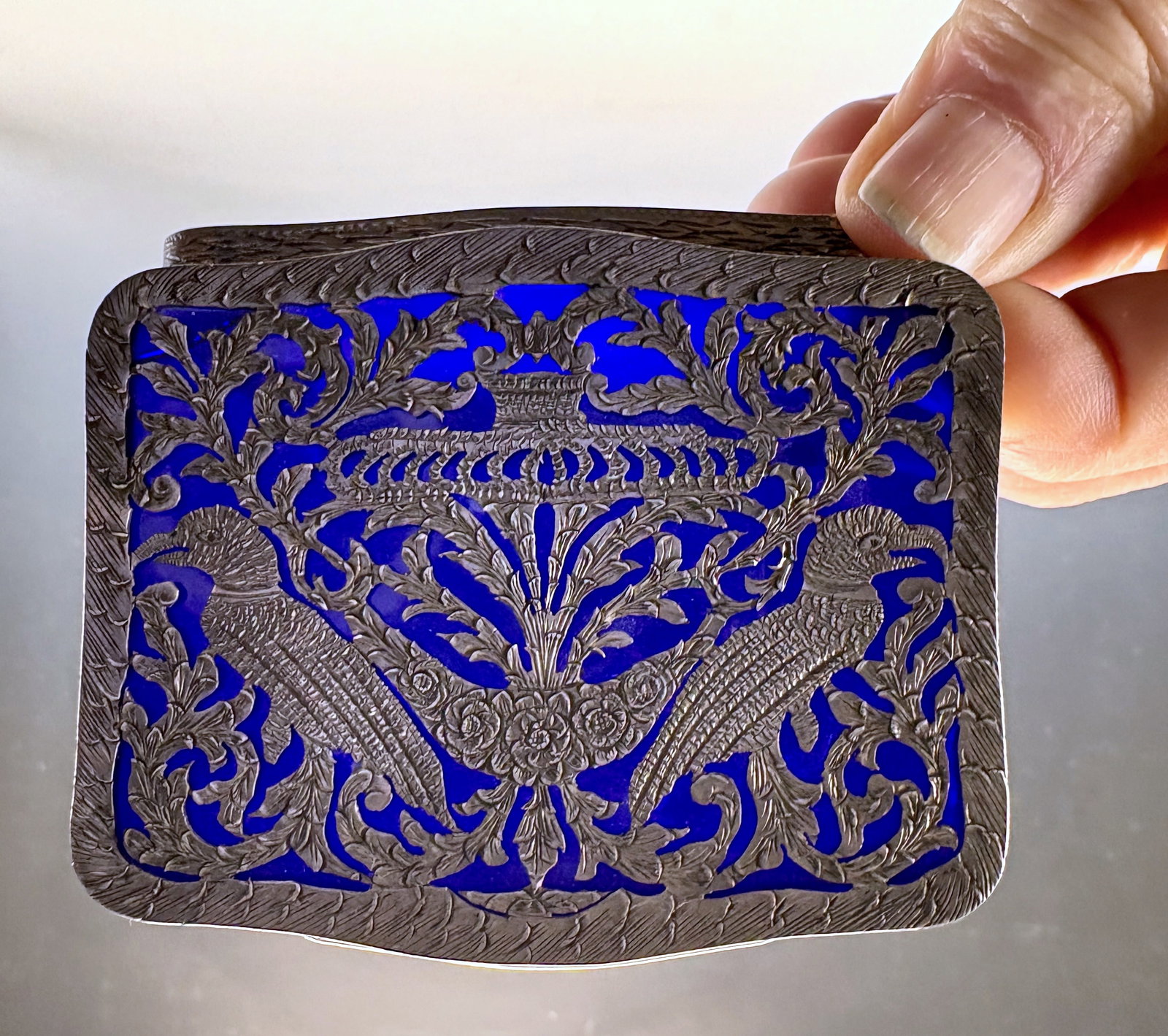 Continental Silver Snuff Box Birds & Cobalt Glass: Circa 1900, a fancy continental silver box with two birds and pireced work over a cobalt glass panel, marked 800 and the letters "LGTF", 3.18" x 2.5" x .625" very good condition
