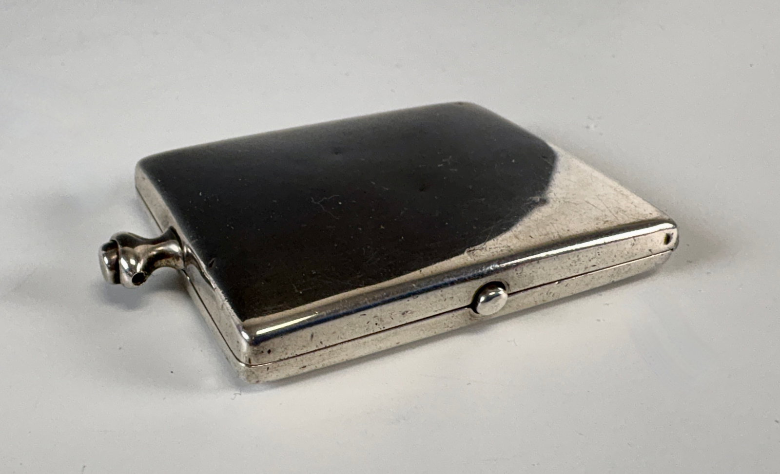 Tiffany & Co Sterling Silver Compact: Circa 1920, vintage Tffany & Co.Sterling silver powder compact with mirror, 60 grams, signed "Tiffany & Co New York", minor dent, missing ring at top, otherwise very good condition, 2" x 1.5"