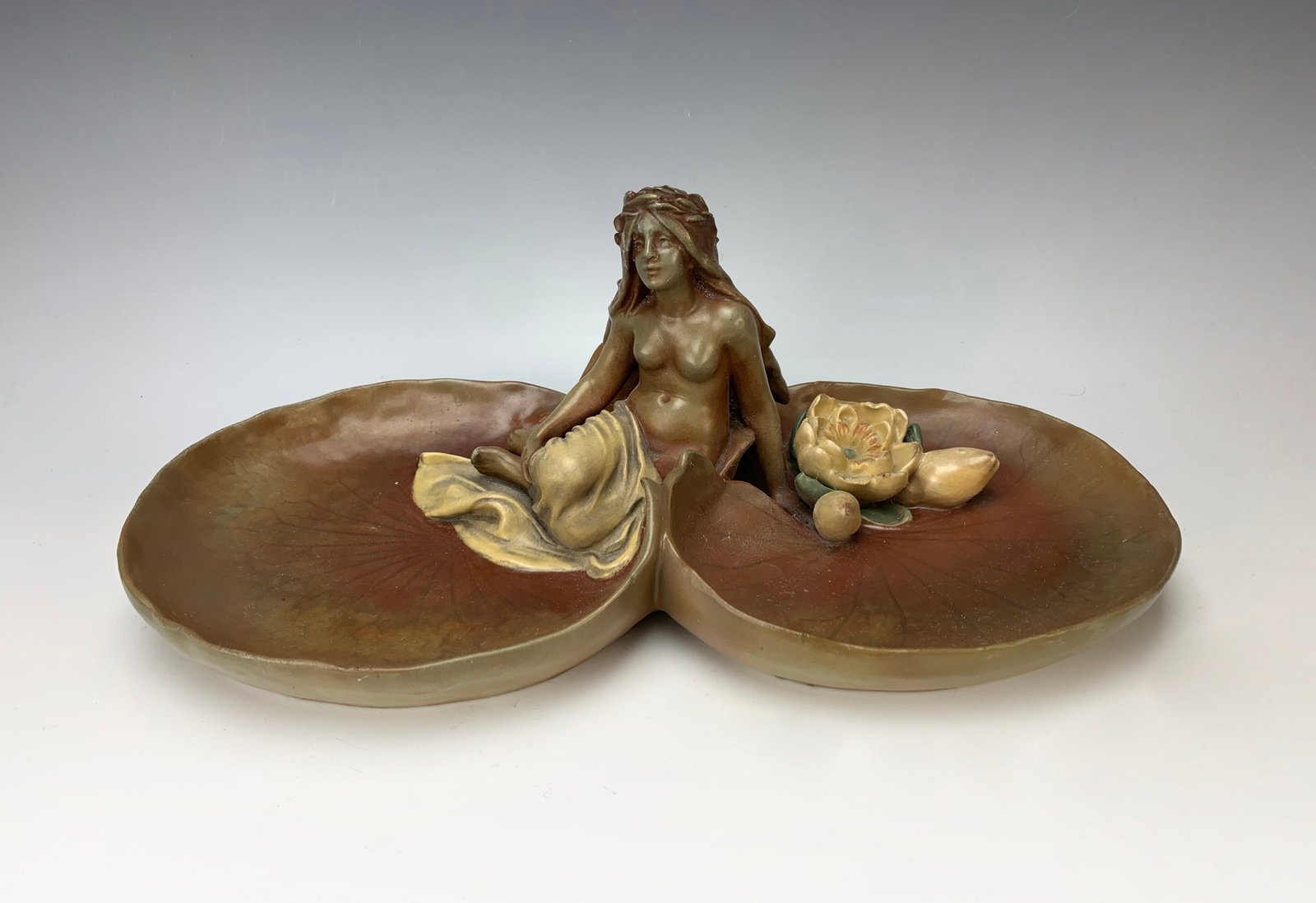 Art Nouveau Nude Dish Sgd Bernard Bloch: Circa 1900. Marked BB for Bernard Block. Having a nude sitting between two lily pads, minor restoration, 15" x 5.5"