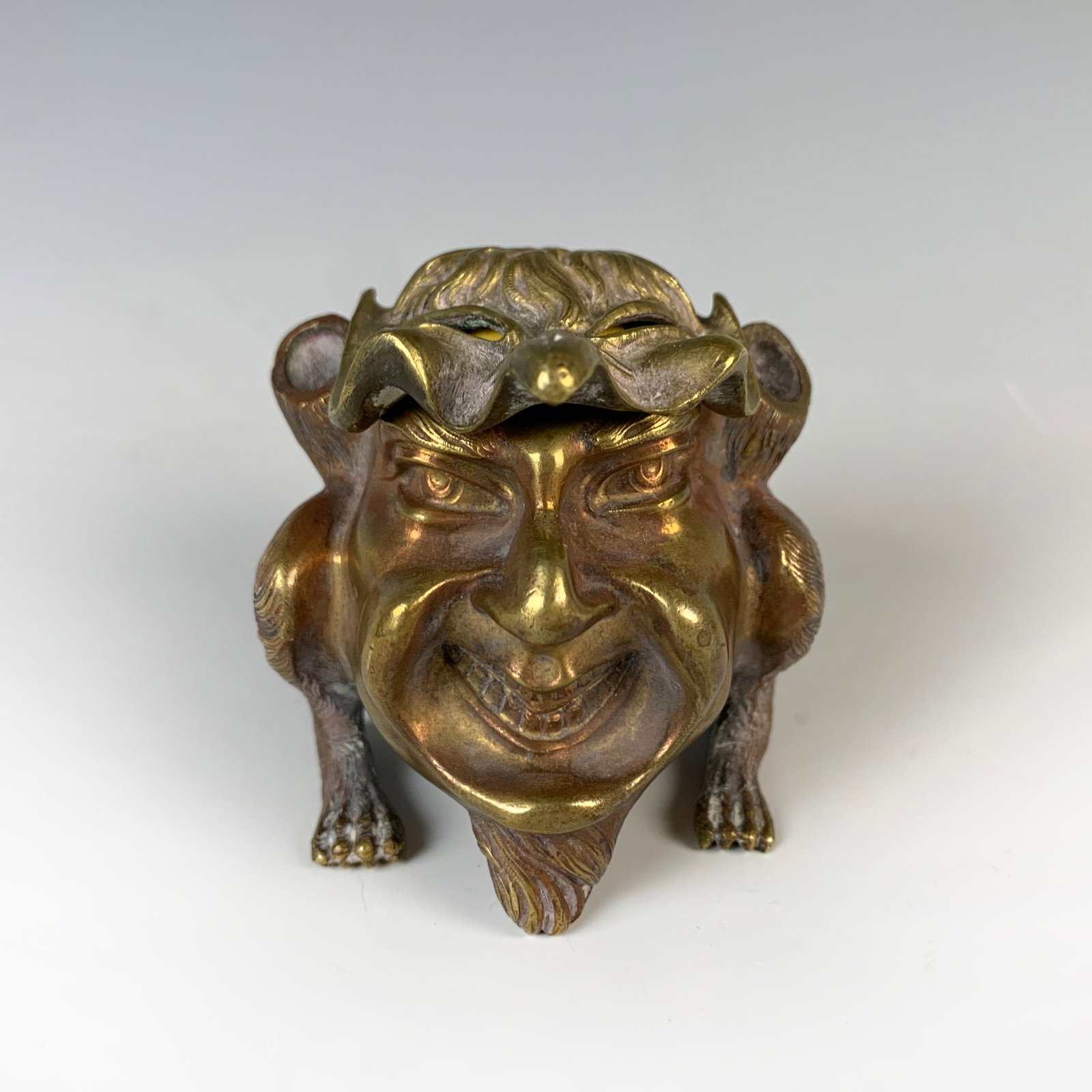 Gilt Bronze Grotesque Inkwell Circa 1900: Circa 1900s. Gilt bronze inkwell in the shape of a grotesque figure, very good condition, 3" tall.