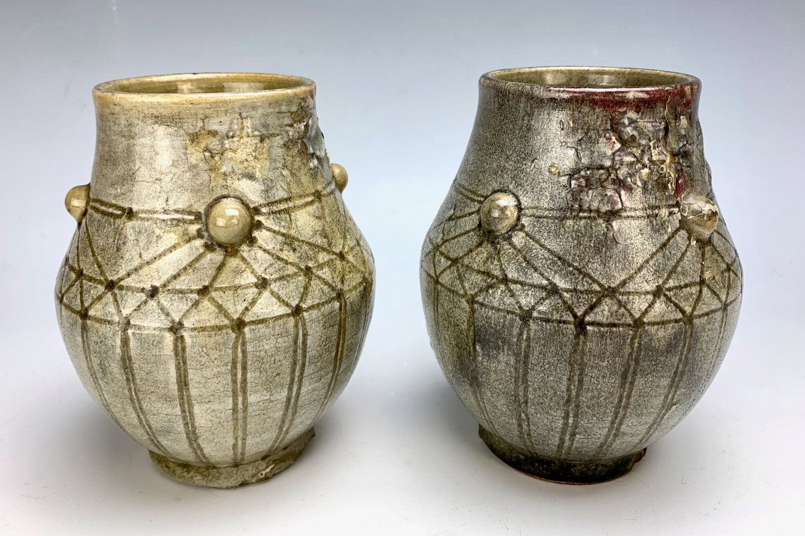 Auguste Delaherche Pair of Vases: Auguste Delaherche (French 1857-1940) a pair of ovoid ceramic vases in grey enameled sandstone decorated with pastilles and geometric linear detail, signed with stamp, two small chips on bottom edge,
