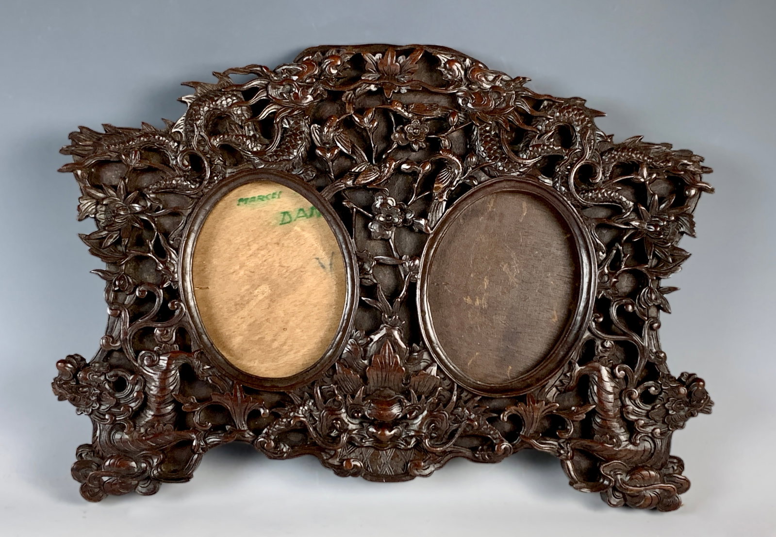 Fancy Chinese Carved Wood Double Frame: Fabulous antique teak carved wood frame decorated with carved dragons, birds, grotesque faces and flowers. very good condition,12" tall x 17" wide. Takes 5.5" x 4.25" photos.
