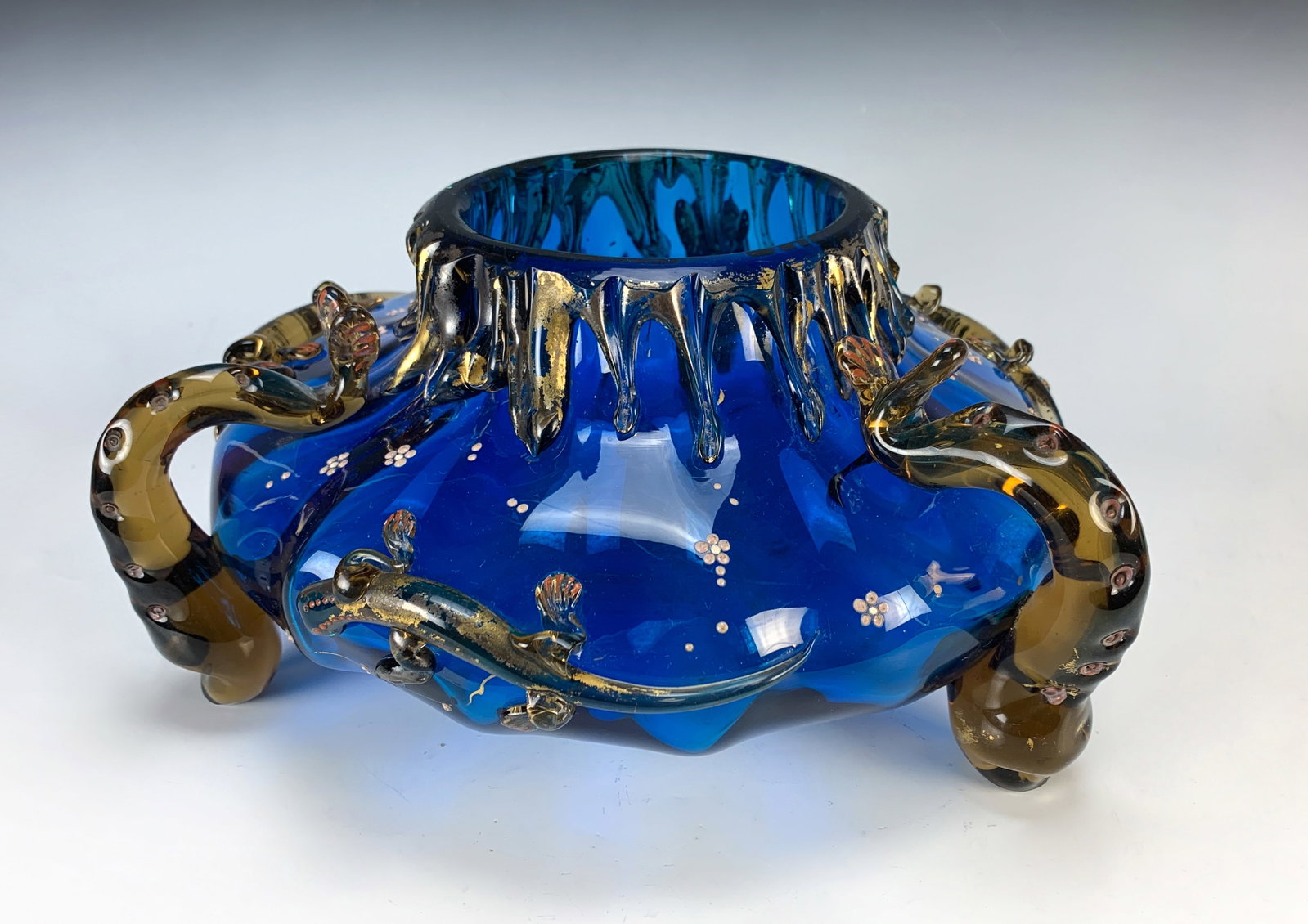 Art Glass Bowl w Salamanders & Fish: Auguste Jean (1830-1890) Attributed, this large flat tripod vase in blue translucent blown glass, having applied glass handles and teardrops on neck, decorated with salamanders, fish and enamel