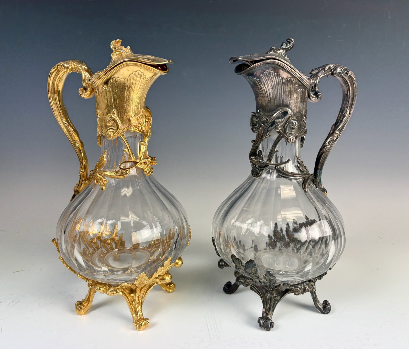 Pair Ornate Gold & Silver Plated Carafes: Two gold and silver plated carafes purported to be from the legendary French restaurant "Le Bouillon Chartier" but we can't guarantee this. They are ornate with gold and silver plating and applied let