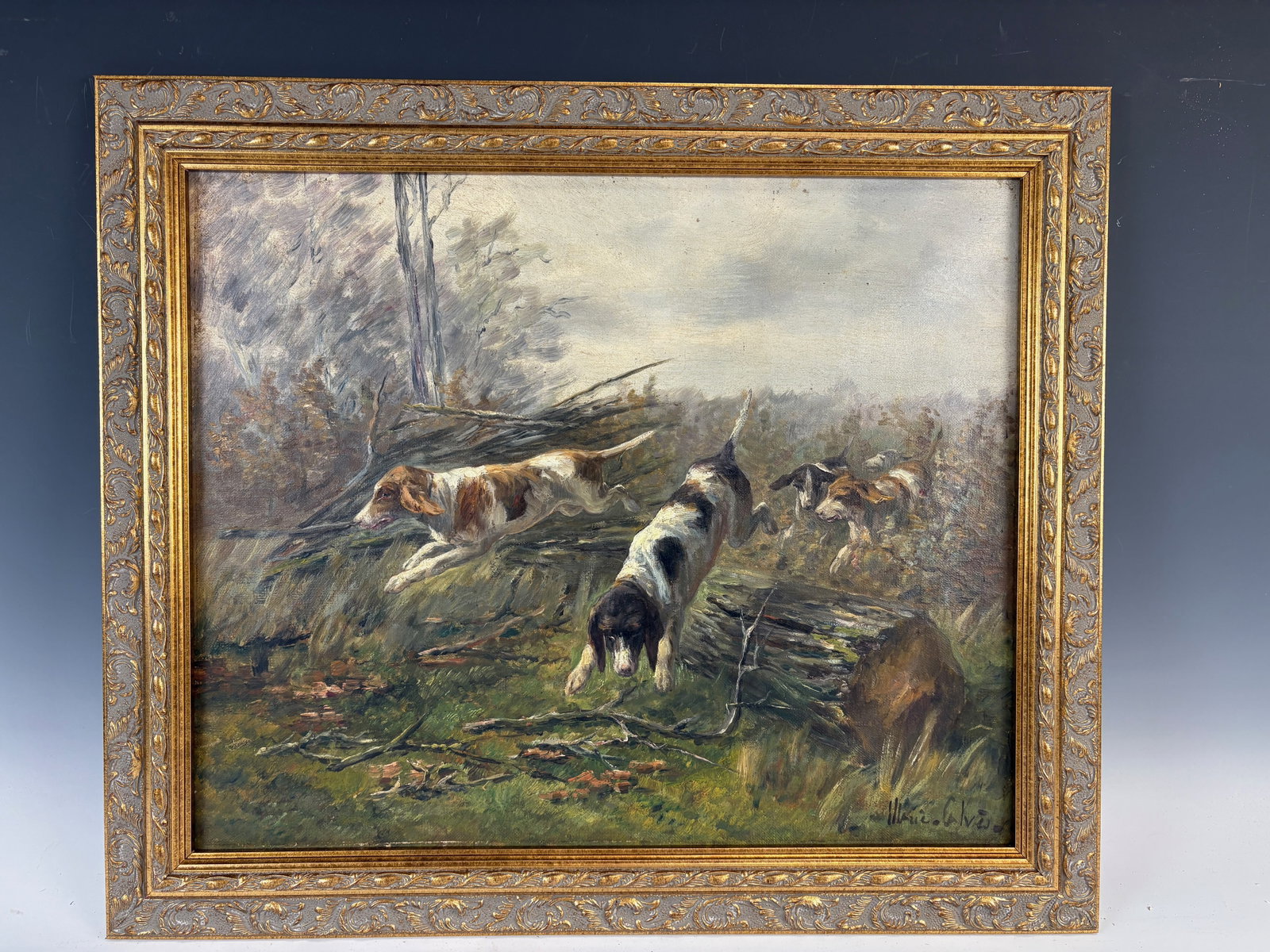 Marie Calves Painting of Dogs on the Hunt: Marie Didiere Calves (1883-1957) oil on canvas of dogs in the field, signed lower right, mounted into an ornate gilt frame, very good condition, sight 15" x 18.25", framed 18.5" x 21.75"
