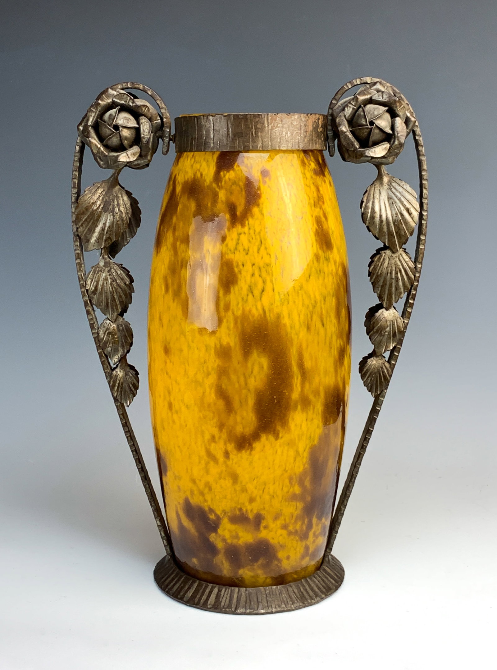 Delatte Nancy Mottled Art Glass & Iron Vase: Andre Delatte (France 1887-1953) large orange and brown speckled mottled glass vase encased in a wrought iron frame with leaves on the handles. Signed on glass "A. Delatte Nancy". Very good condition,