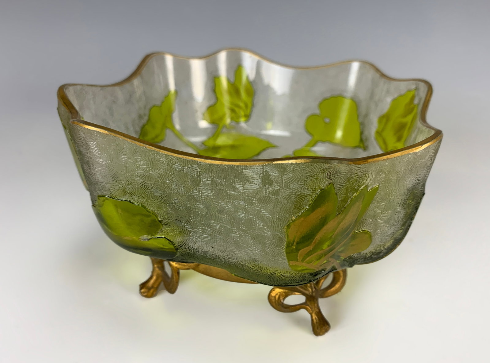 Baccarat Cameo Glass Bowl with Bronze Base: A Baccarat footed multi-layer crystal bowl of undulating form, clear acid-washed body with cameo green flowers, mounted into a gilt bronze four-legged stand, signed with the Baccarat logo, good condit