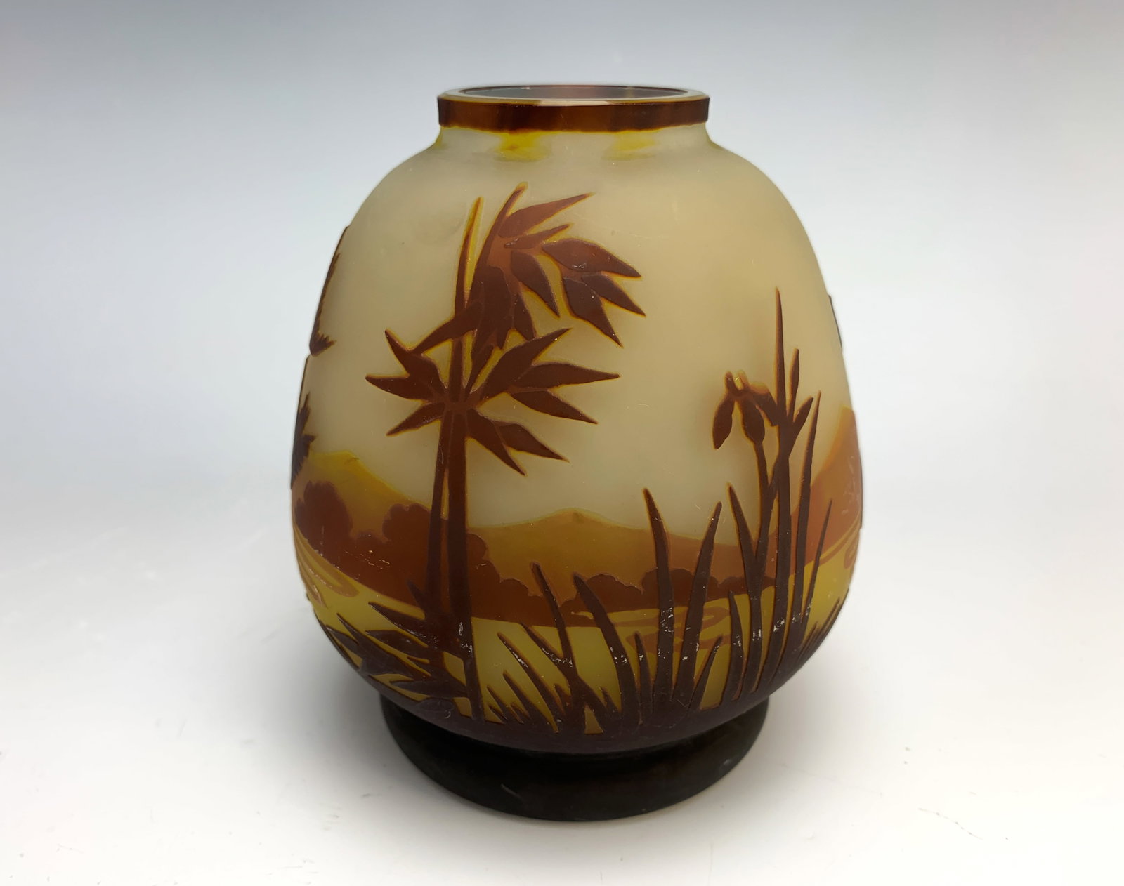 Muller Freres Luneville Cameo Art Glass Vase: A multi layered cameo glass vase signed "Muller Fres Luneville" the frosted glass body decorated with a deep crimson heron approaching a flock of birds against amber and orange ground, very good condi