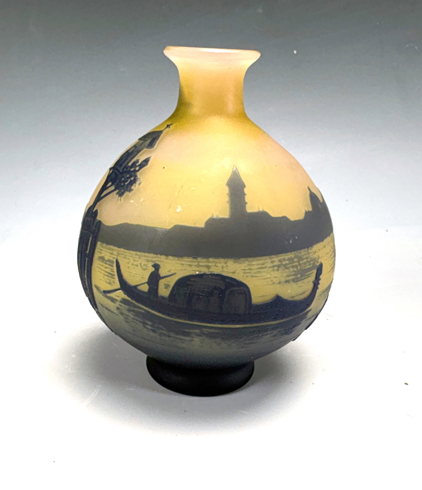 DeVez French Cameo Glass Vase: Circa 1900, French cameo art glass scenic vase with beautiful Venetian scene of boats in a canal, blue cameo over a yellow pink body,signed in cameo "DeVez", 4" x 3", very good condition.Eligible for 