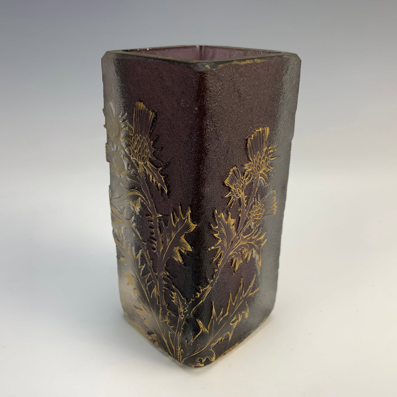 Daum Nancy "Thistles" Cameo Glass Vase: Square-shaped vase in two layers of violet and clear frosted glass. Acid-etched decoration of thistle branches in bloom, with gold highlights over a frosted clear and violet ground. Signed on the bott