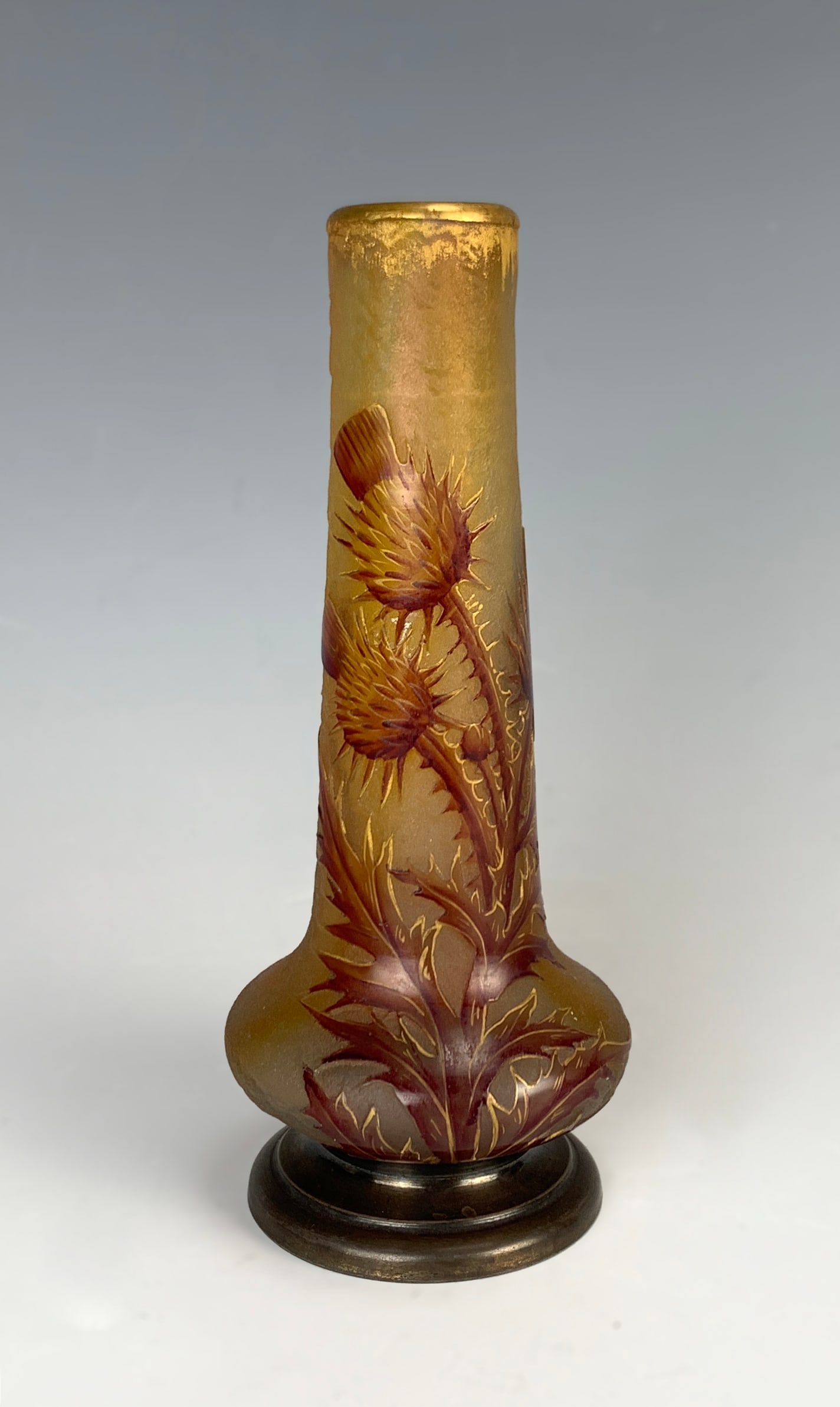 Daum Nancy Thistle Vase w Silver Base: Circa 1900s. Daum Nancy "Thistle" cameo glass vase decorated with enameled thistle plants with hallmarked silver base, vase signed "Daum Nancy" with Cross of Lorraine. Very good condition, 5.25" tall.