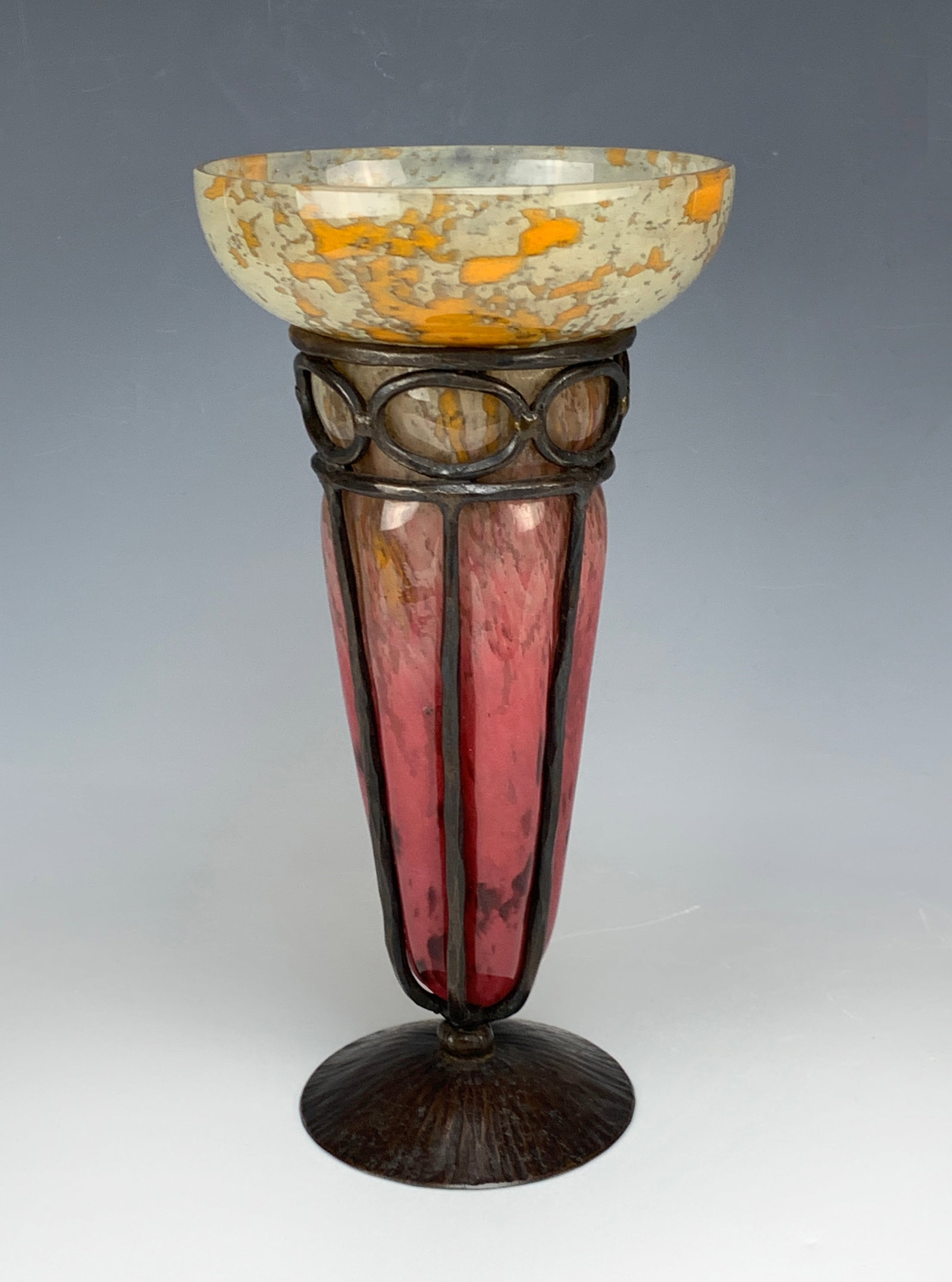C. Schneider (1881-1952) Art Deco Glass&Iron Vase: Beautiful Art Deco mottled glass + iron vase in colors of red on the bottom half changing into a white/orange top, encased in a wrought iron frame. Signed "Schneider" on the side of the vase. Size: 11